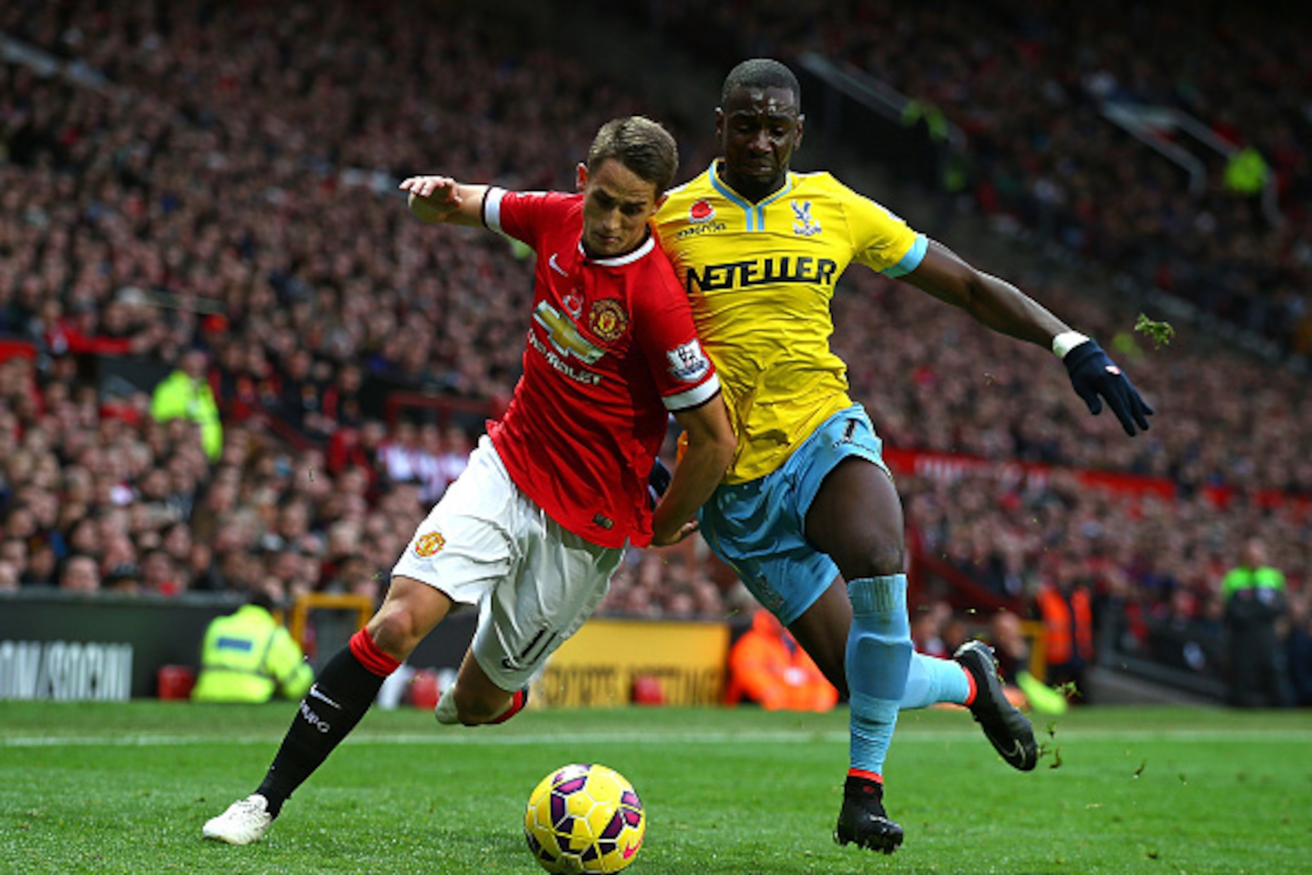 MANCHESTER, ENGLAND - NOVEMBER 08:  Adnan Januzaj of Manchester United competes with Yannick Bolasie of Crystal Palace during the Barclays Premier League match between Manchester United and Crystal Palace at Old Trafford on November 8, 2014 in Manchester,