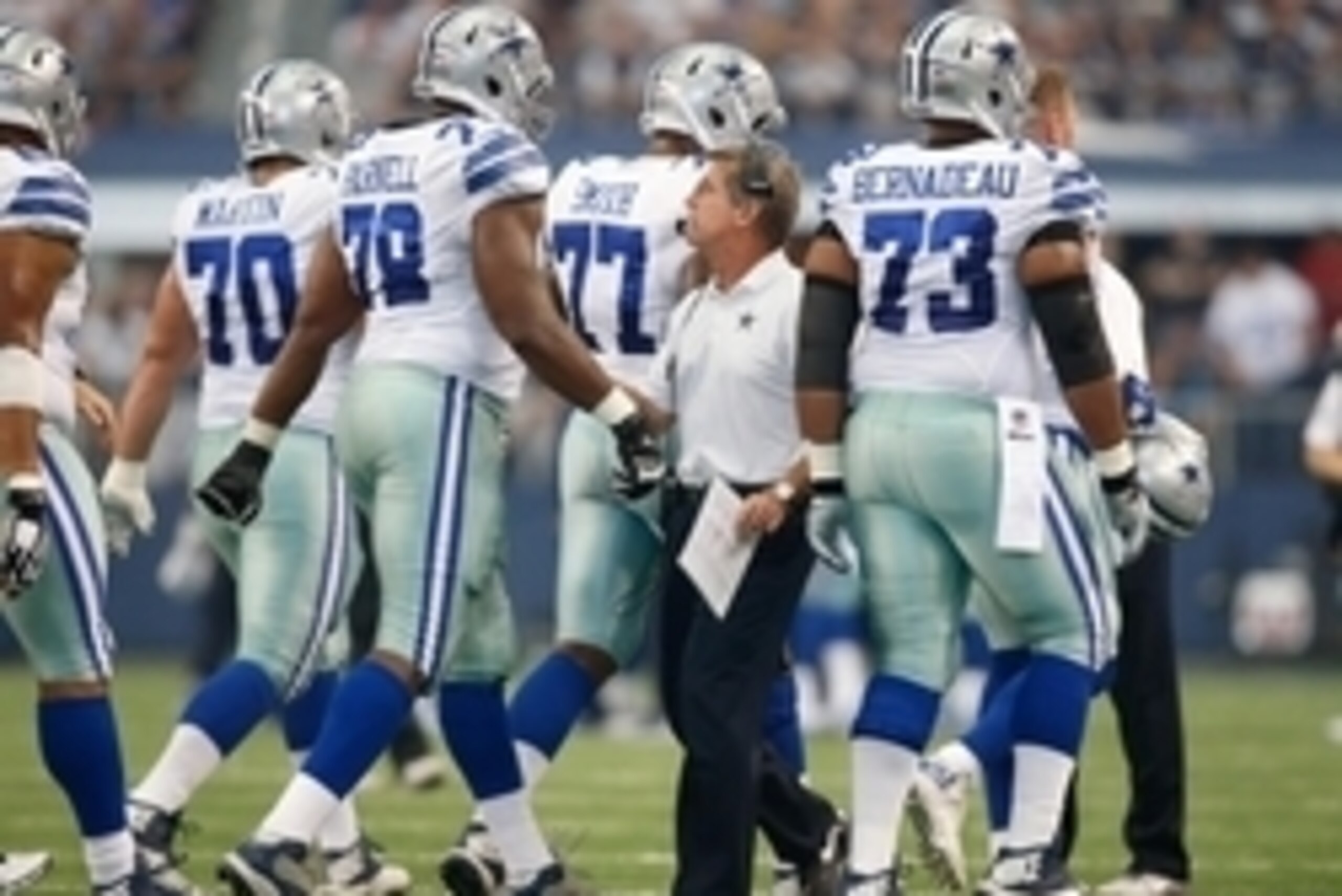 Oct 19, 2014; Arlington, TX, USA; Dallas Cowboys offensive coordinator Bill Callahan congratulates offensive lineman as they leave the field during the game against the New York Giants at AT&T Stadium.  Dallas beat New York 31-21. Mandatory Credit: Tim He