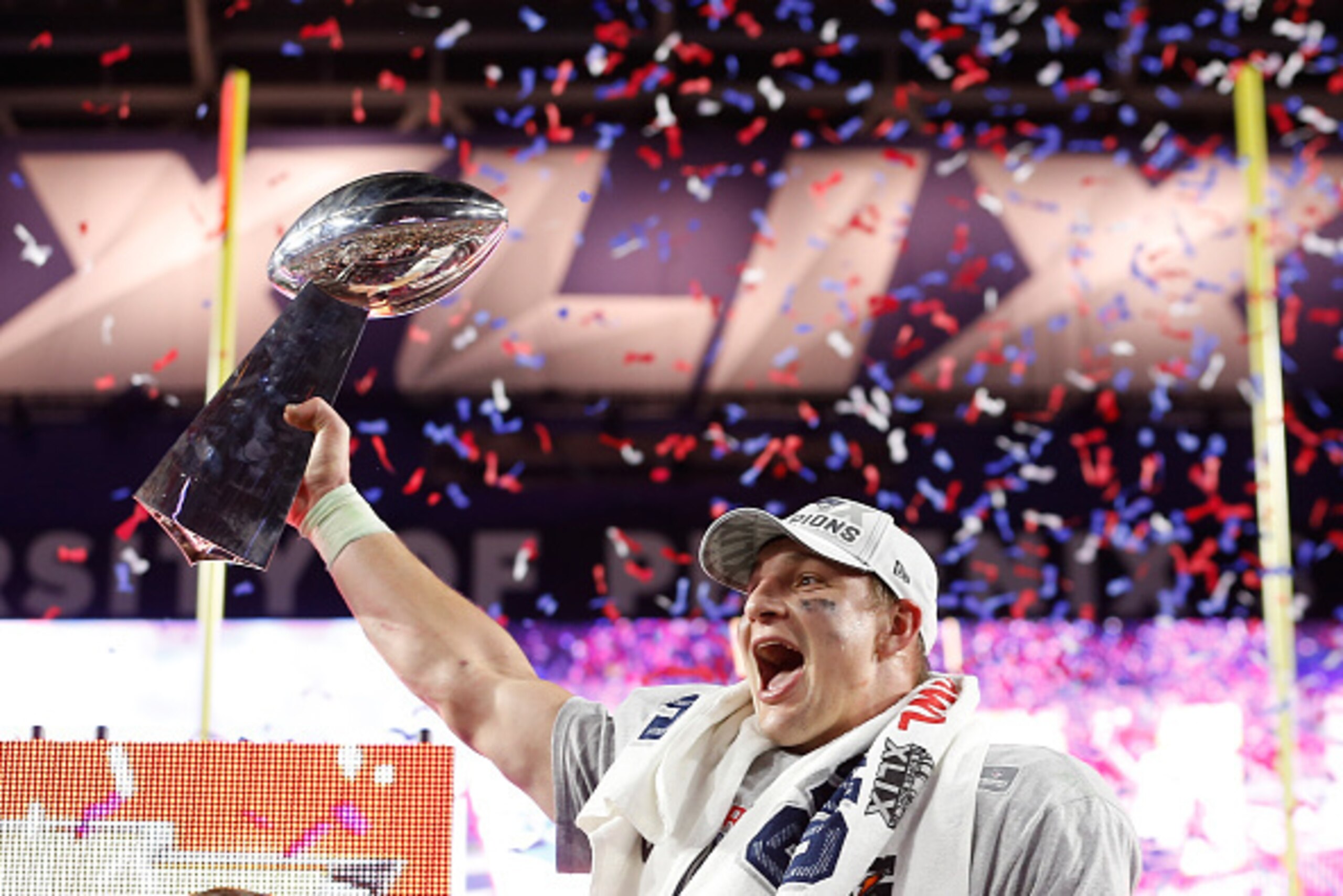 GLENDALE, AZ - FEBRUARY 01: Rob Gronkowski #87 of the New England Patriots celebrates with the Vince Lombardi Trophy at the trophy ceremony after defeating the Seattle Seahawks 28-24 to win Super Bowl XLIX at University of Phoenix Stadium on February 1, GLENDALE, AZ - FEBRUARY 01: Rob Gronkowski #87 of the New England Patriots celebrates with the Vince Lombardi Trophy at the trophy ceremony after defeating the Seattle Seahawks 28-24 to win Super Bowl XLIX at University of Phoenix Stadium on February 1,