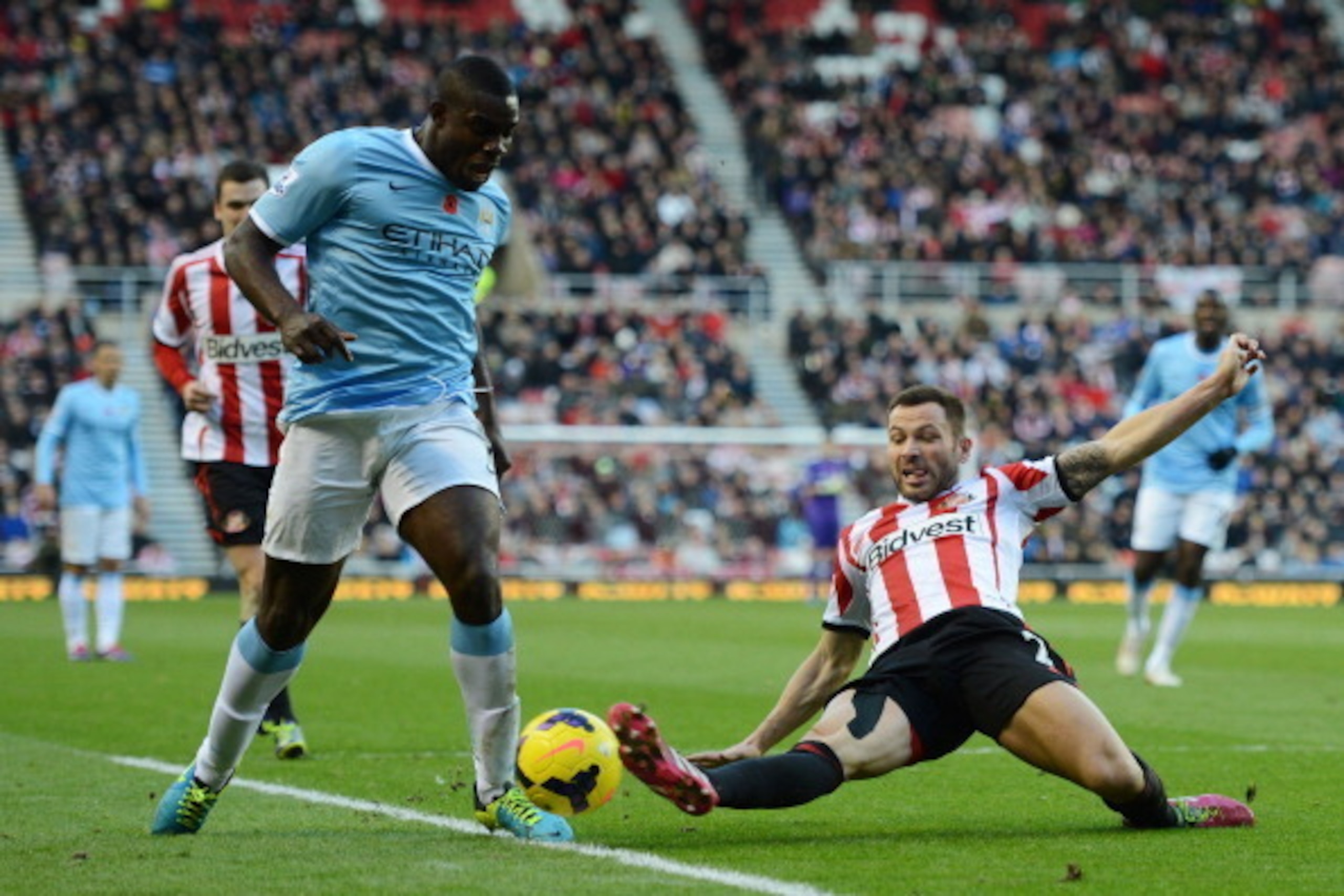 SUNDERLAND, ENGLAND - NOVEMBER 10: Micah Richards of Manchester City is challenged by Phillip Bardsley of Sunderland during the Barclays Premier League match between Sunderland and Manchester City at the Stadium of Light on November 10, 2013 in Sunderland