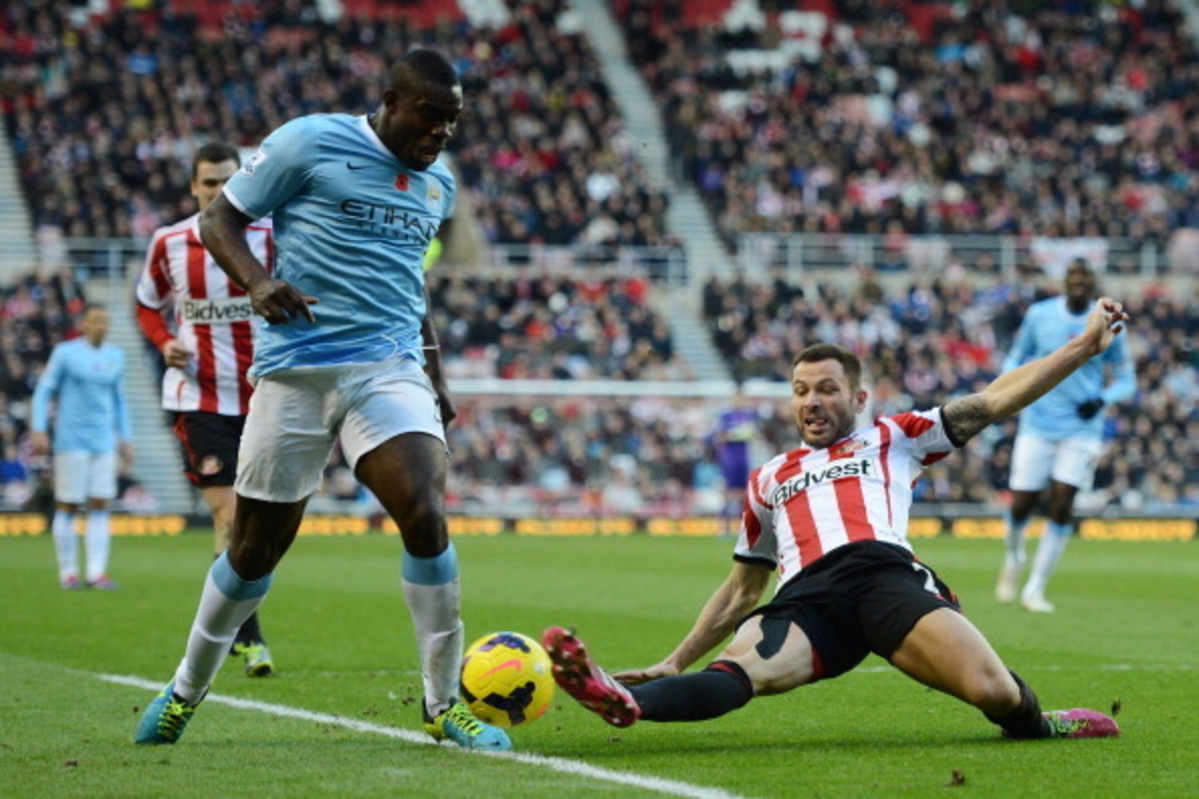 SUNDERLAND, ENGLAND - NOVEMBER 10: Micah Richards of Manchester City is challenged by Phillip Bardsley of Sunderland during the Barclays Premier League match between Sunderland and Manchester City at the Stadium of Light on November 10, 2013 in Sunderland