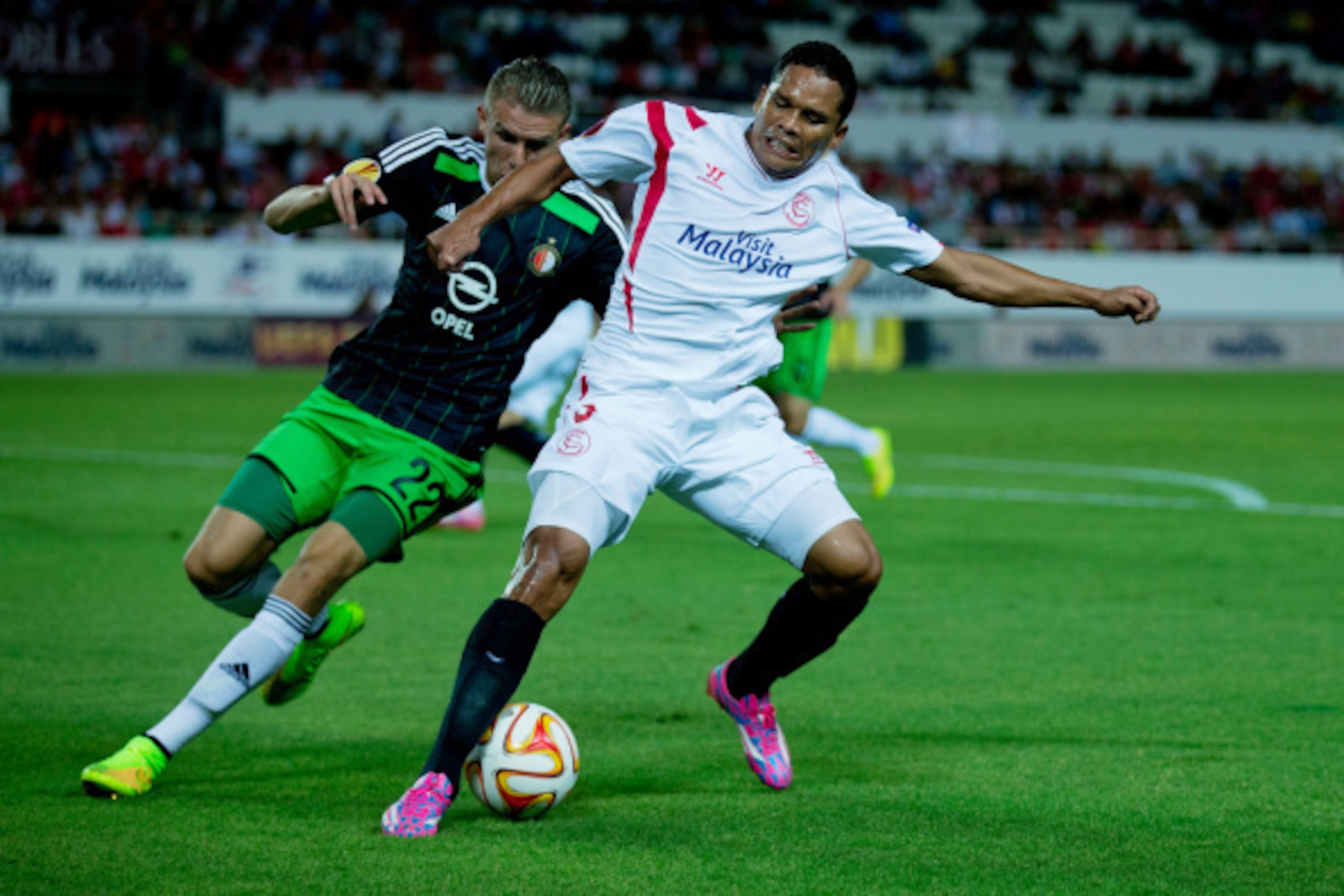SEVILLE, SPAIN - SEPTEMBER 18: Carlos Bacca (L) of Sevilla FC competes for the ball with Sven van Beek (L) of Feyenoord during the UEFA Europa League group G match between Sevilla FC and Feyenoord at Ramon Sanchez Pizjuan stadium on September 18, 2014 in SEVILLE, SPAIN - SEPTEMBER 18: Carlos Bacca (L) of Sevilla FC competes for the ball with Sven van Beek (L) of Feyenoord during the UEFA Europa League group G match between Sevilla FC and Feyenoord at Ramon Sanchez Pizjuan stadium on September 18, 2014 in
