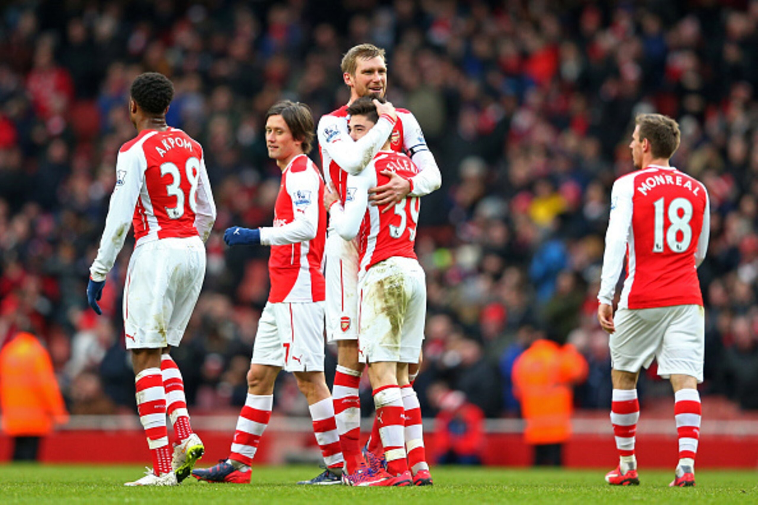 LONDON, ENGLAND - FEBRUARY 01:  Hector Bellerin #39 of Arsenal is congratulated by teammate Per Mertesacker of Arsenal after scoring his team's fifth goal during the Barclays Premier League match between Arsenal and Aston Villa at the Emirates Stadium on 