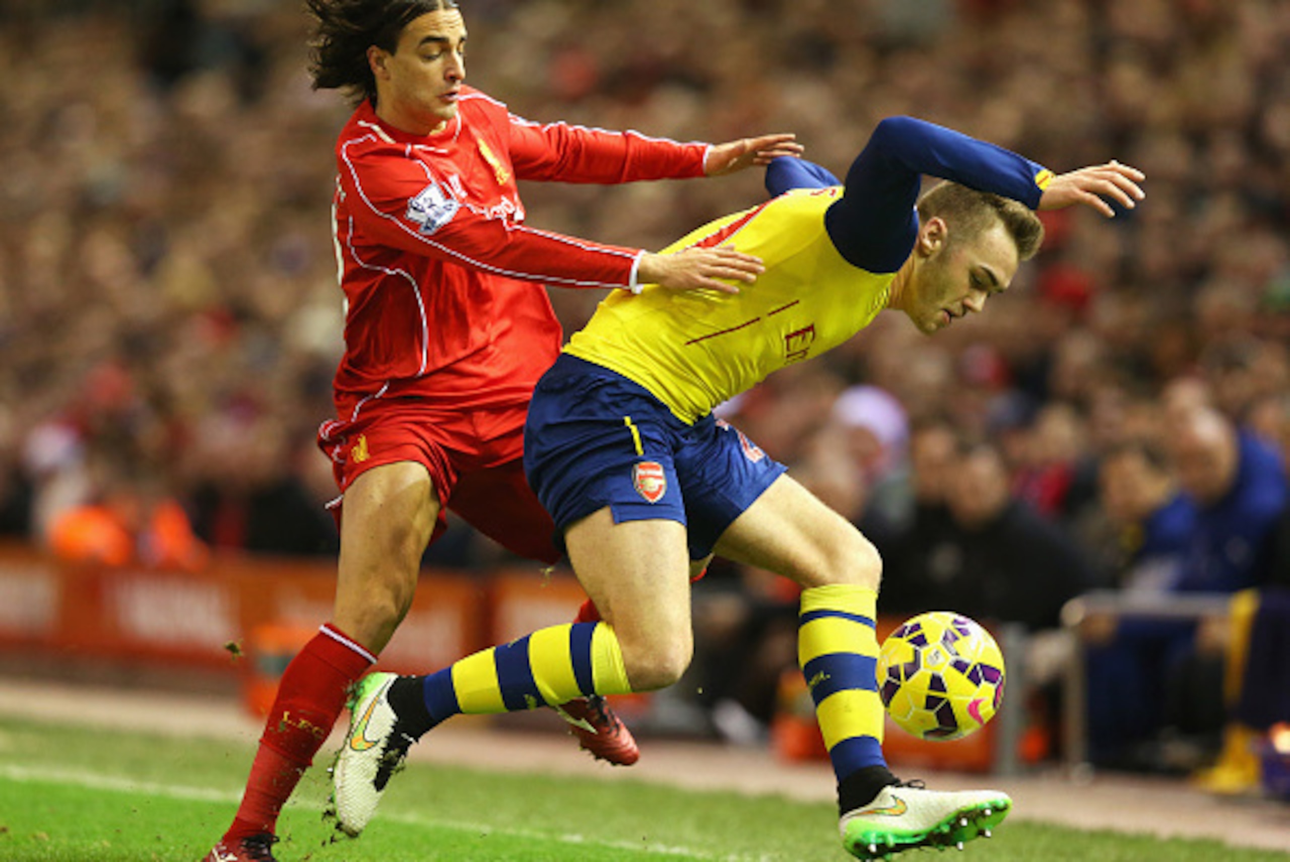 LIVERPOOL, ENGLAND - DECEMBER 21:  Lazar Markovic of Liverpool challenges Calum Chambers of Arsenal during the Barclays Premier League match between Liverpool and Arsenal at Anfield on December 21, 2014 in Liverpool, England.  (Photo by Alex Livesey/Getty