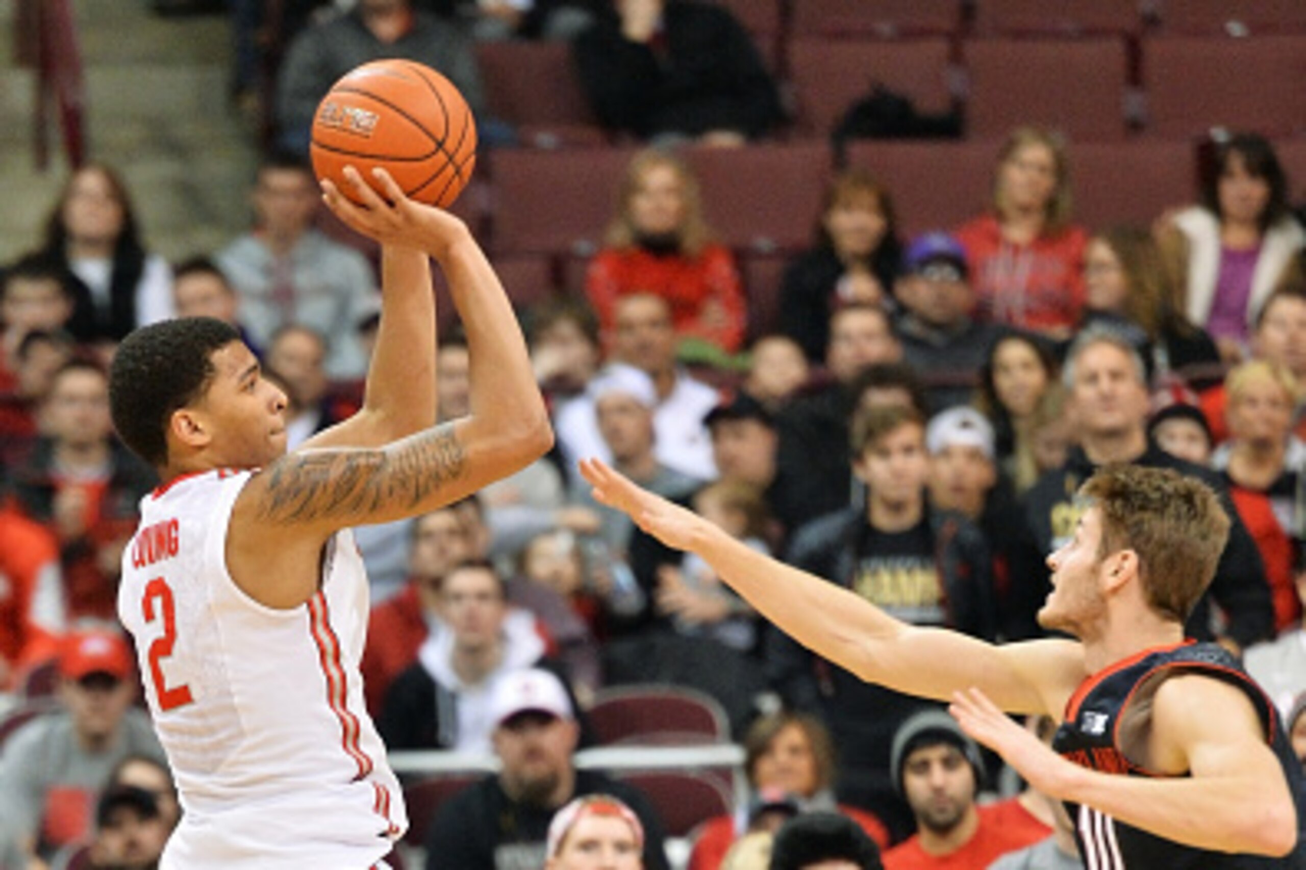 COLUMBUS, OH - JANUARY 29:  Marc Loving #2 of the Ohio State Buckeyes shoots a three-pointer over Jake Layman #10 of the Maryland Terrapins in the first half on January 29, 2015 at Value City Arena in Columbus, Ohio.  (Photo by Jamie Sabau/Getty Images)