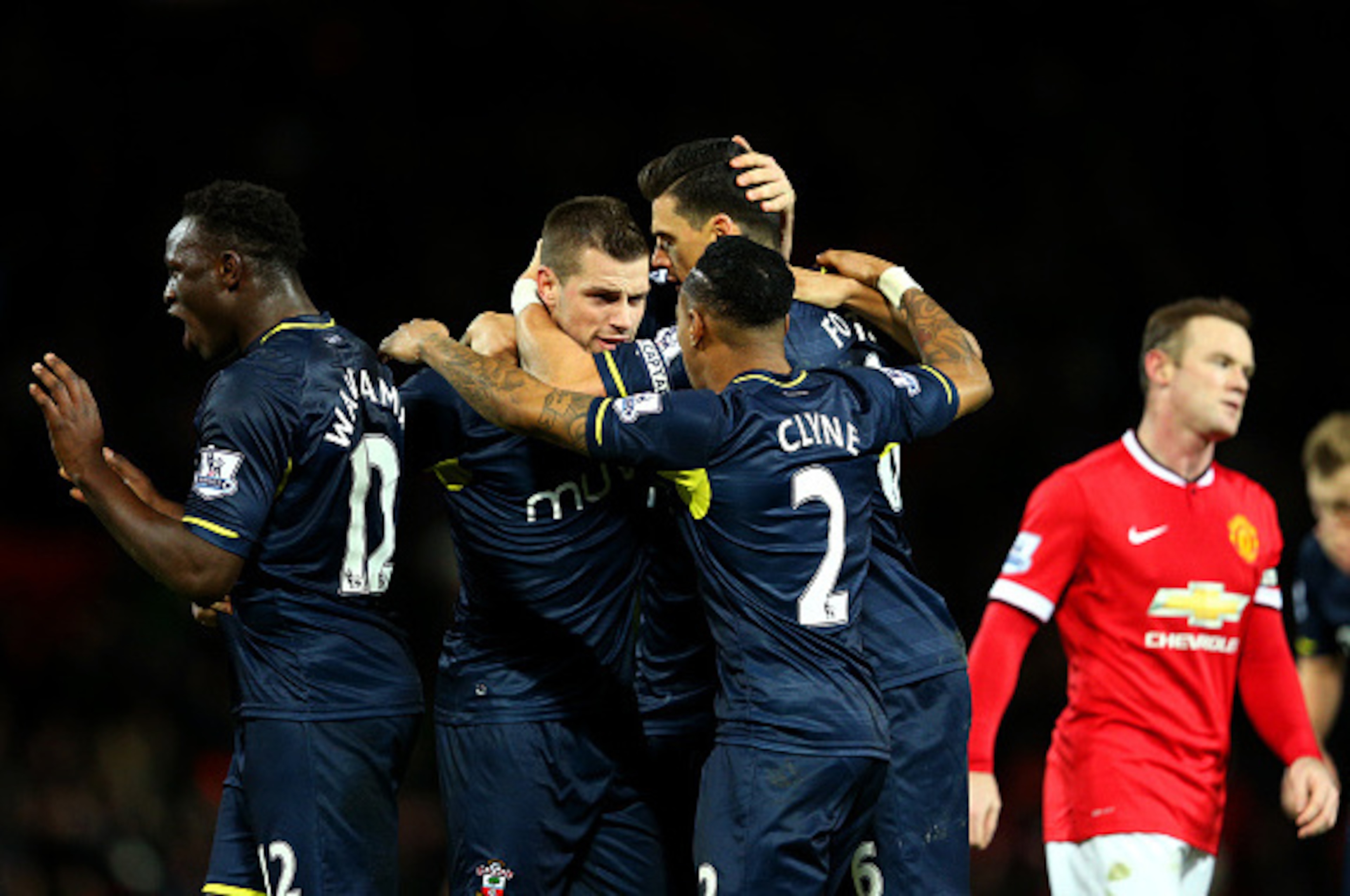 MANCHESTER, ENGLAND - JANUARY 11:  Wayne Rooney of Manchester United reacts as Southampton players celebrate victory after the Barclays Premier League match between Manchester United and Southampton at Old Trafford on January 11, 2015 in Manchester, Engla