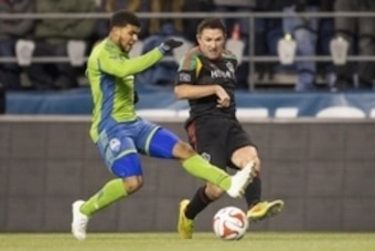 Nov 30, 2014; Seattle, WA, USA; Los Angeles Galaxy forward Robbie Keane (7) puts a pass in front of Seattle Sounders FC defender DeAndre Yedlin (17) during the first half of the Western Conference Championship at CenturyLink Field. Mandatory Credit: Joe N