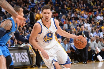 OAKLAND, CA - FEBRUARY 4: Klay Thompson #11 of the Golden State Warriors drives against the Dallas Mavericks on February 4, 2015 at Oracle Arena in Oakland, California. NOTE TO USER: User expressly acknowledges and agrees that, by downloading and or using