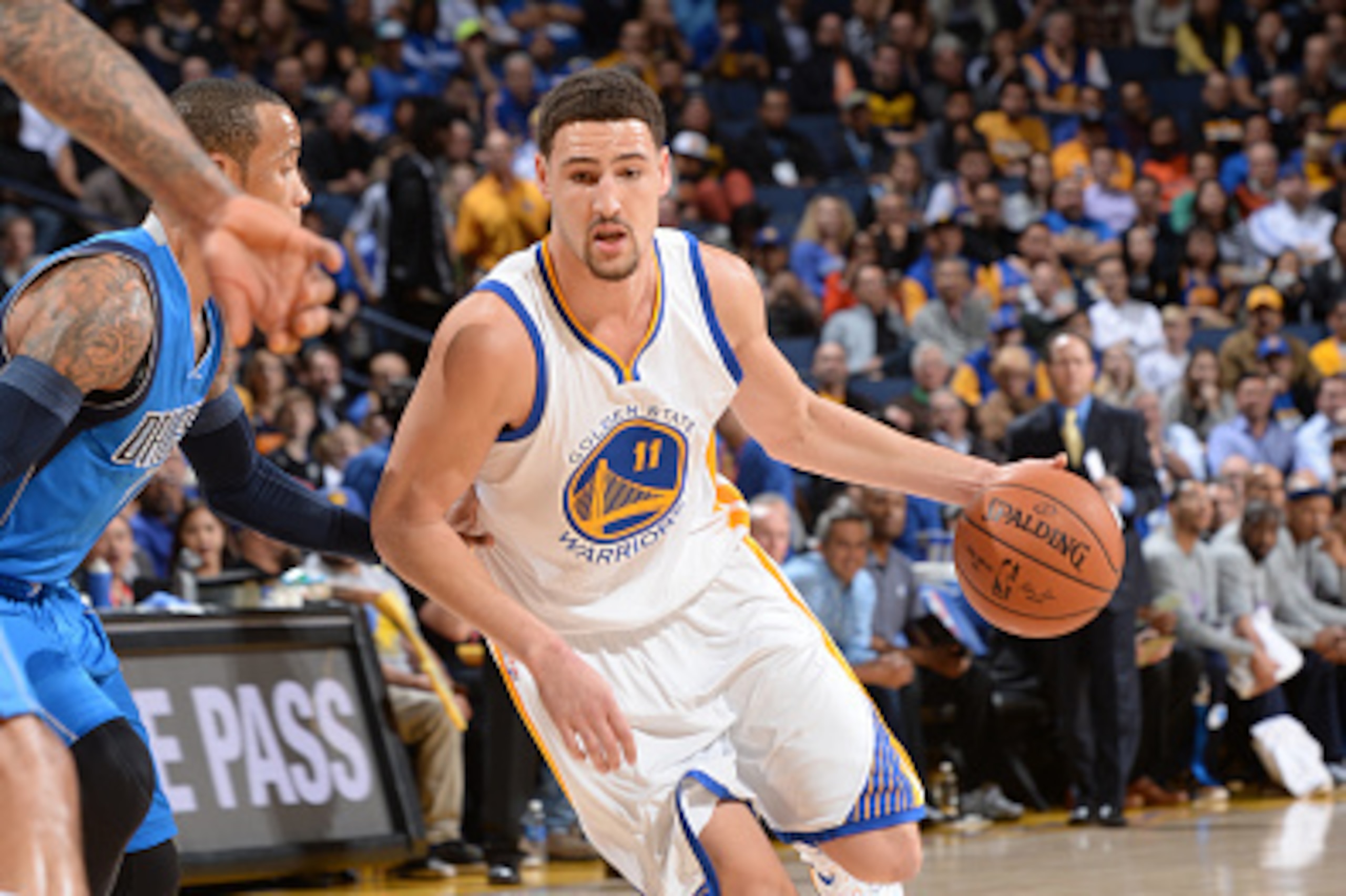 OAKLAND, CA - FEBRUARY 4: Klay Thompson #11 of the Golden State Warriors drives against the Dallas Mavericks on February 4, 2015 at Oracle Arena in Oakland, California. NOTE TO USER: User expressly acknowledges and agrees that, by downloading and or using