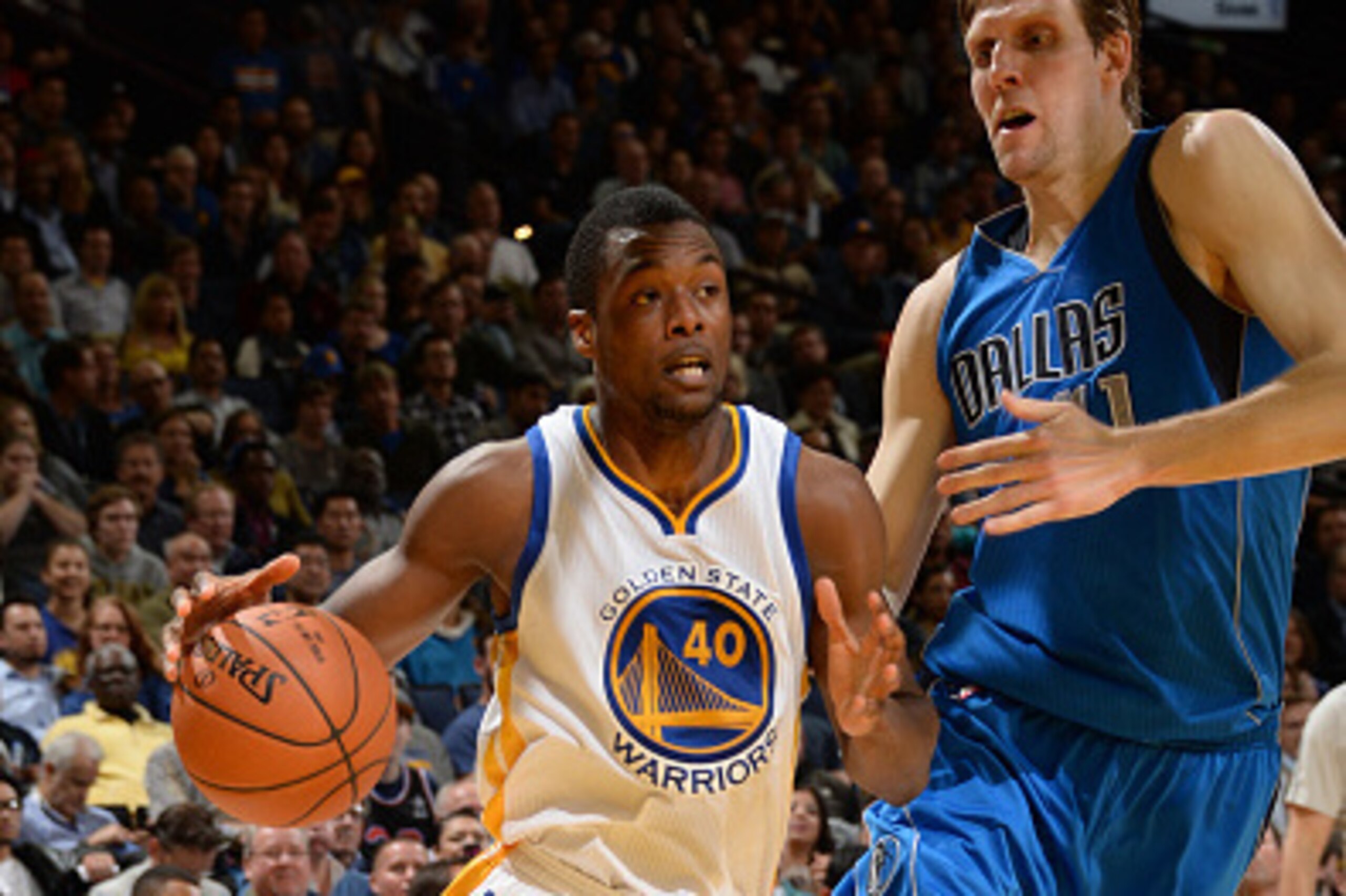 OAKLAND, CA - FEBRUARY 4: Harrison Barnes #40 of the Golden State Warriors drives to the basket against Dirk Nowitzki #41 of the Dallas Mavericks at Oracle Arena on February 4, 2015 in Oakland, California. NOTE TO USER: User expressly acknowledges and agr