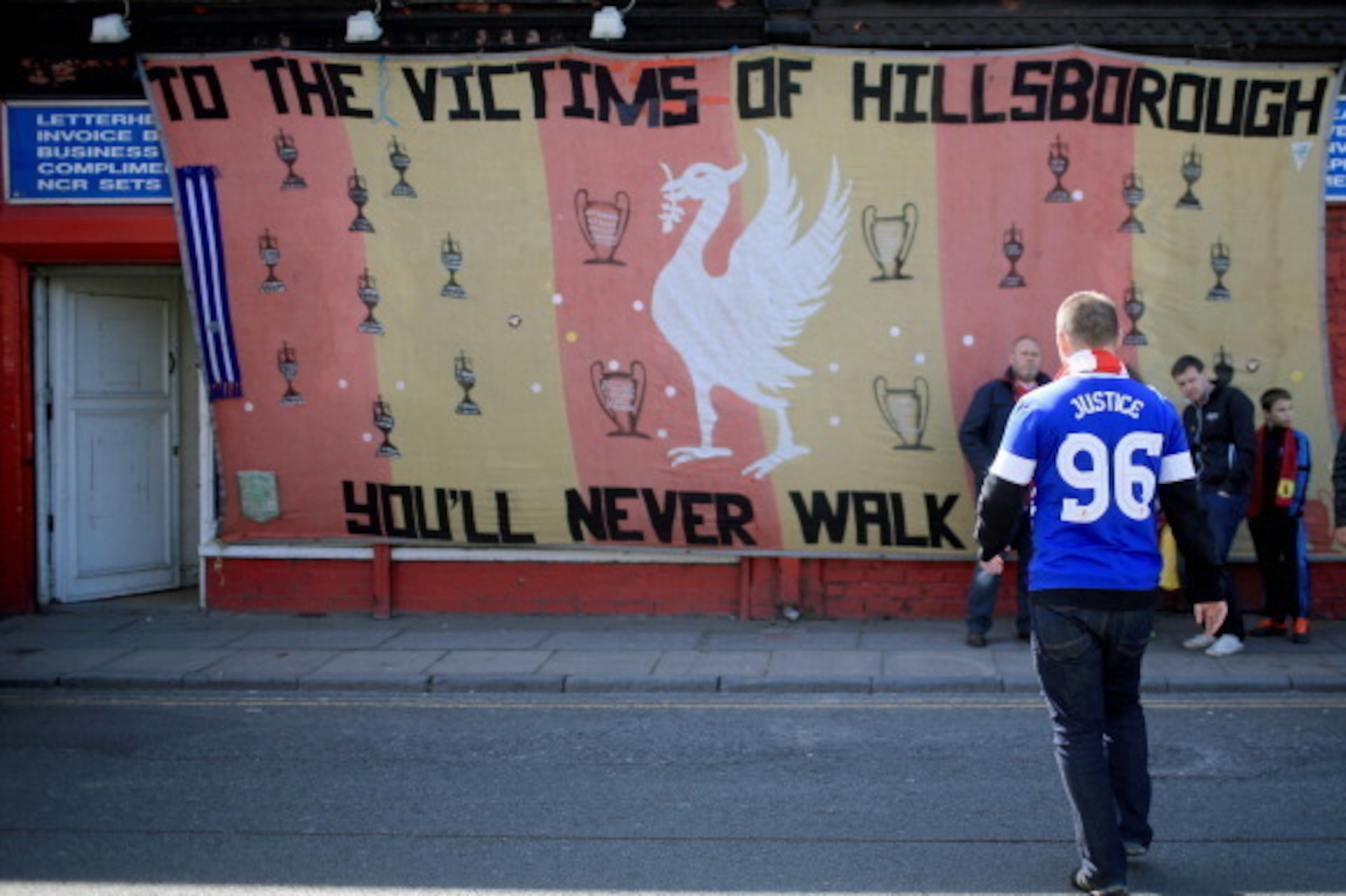 LIVERPOOL, ENGLAND - APRIL 15: An Everton fan arrives in Anfield for a memorial service marking the 25th anniversary of the Hillsborough Disaster at Anfield stadium on April 15, 2014 in Liverpool, England. Thousands of fans, friends and relatives are att LIVERPOOL, ENGLAND - APRIL 15: An Everton fan arrives in Anfield for a memorial service marking the 25th anniversary of the Hillsborough Disaster at Anfield stadium on April 15, 2014 in Liverpool, England. Thousands of fans, friends and relatives are att