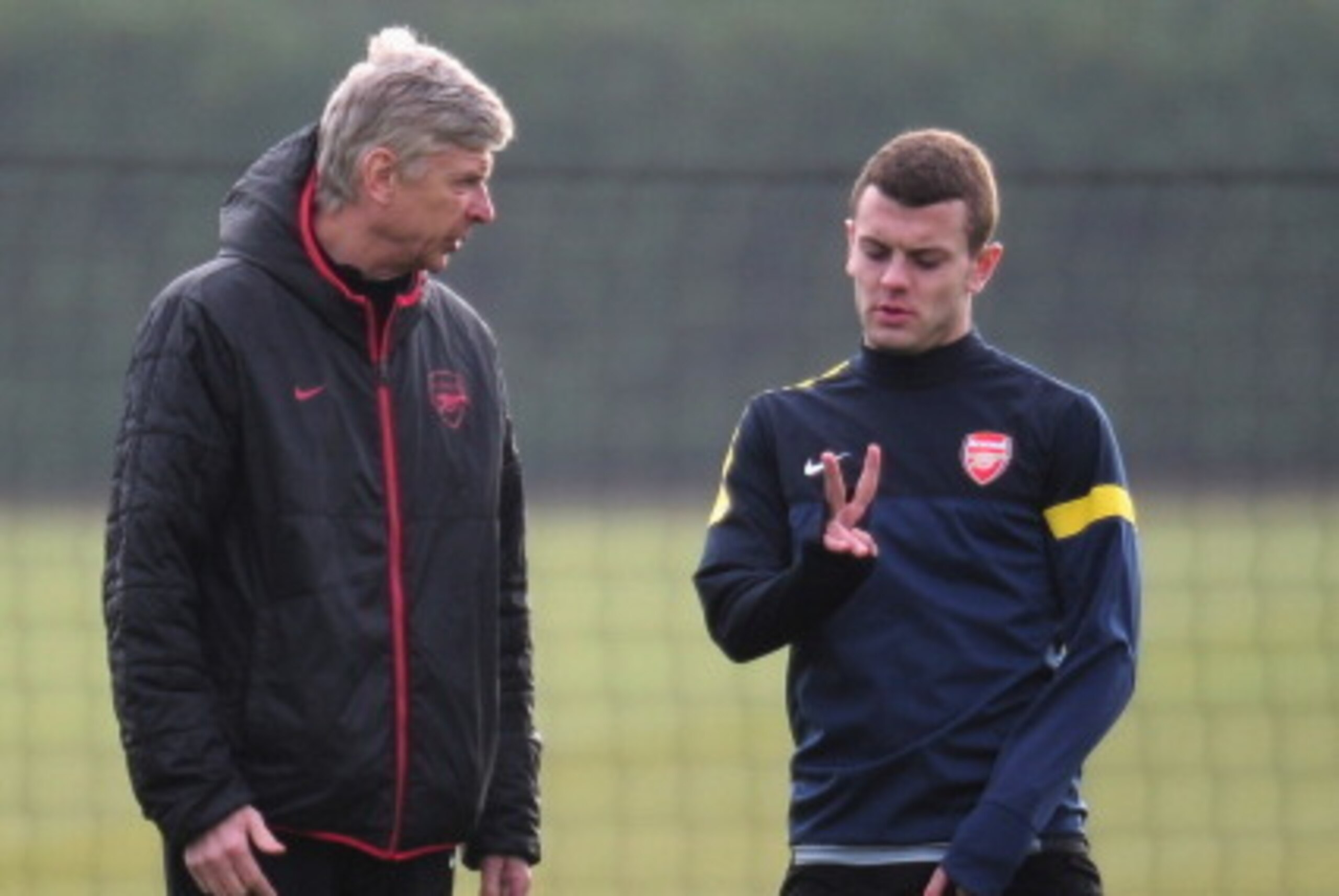 ST ALBANS, ENGLAND - FEBRUARY 18:  Arsenal manager Arsene Wenger talks to Jack Wilshere during a training session ahead of their UEFA Champions League round of 16 first leg match against FC Bayern Muenchen at London Colney on February 18, 2013 in St Alban