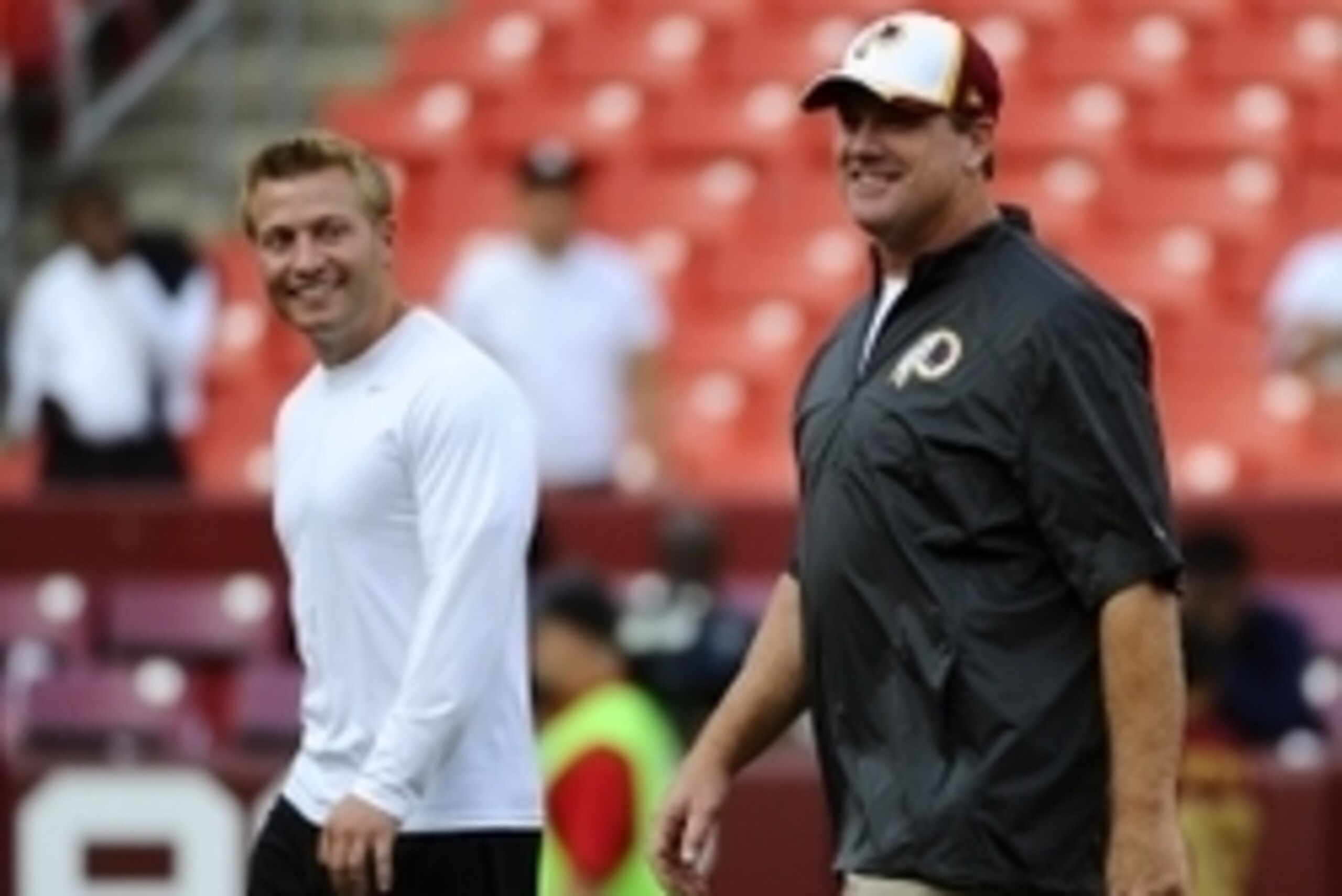 Aug 18, 2014; Landover, MD, USA; Washington Redskins head coach Jay Gruden and offensive coordinator Sean McVay on talk on the field before the game between the Washington Redskins and the Cleveland Browns at FedEx Field. Mandatory Credit: Brad Mills-USA 