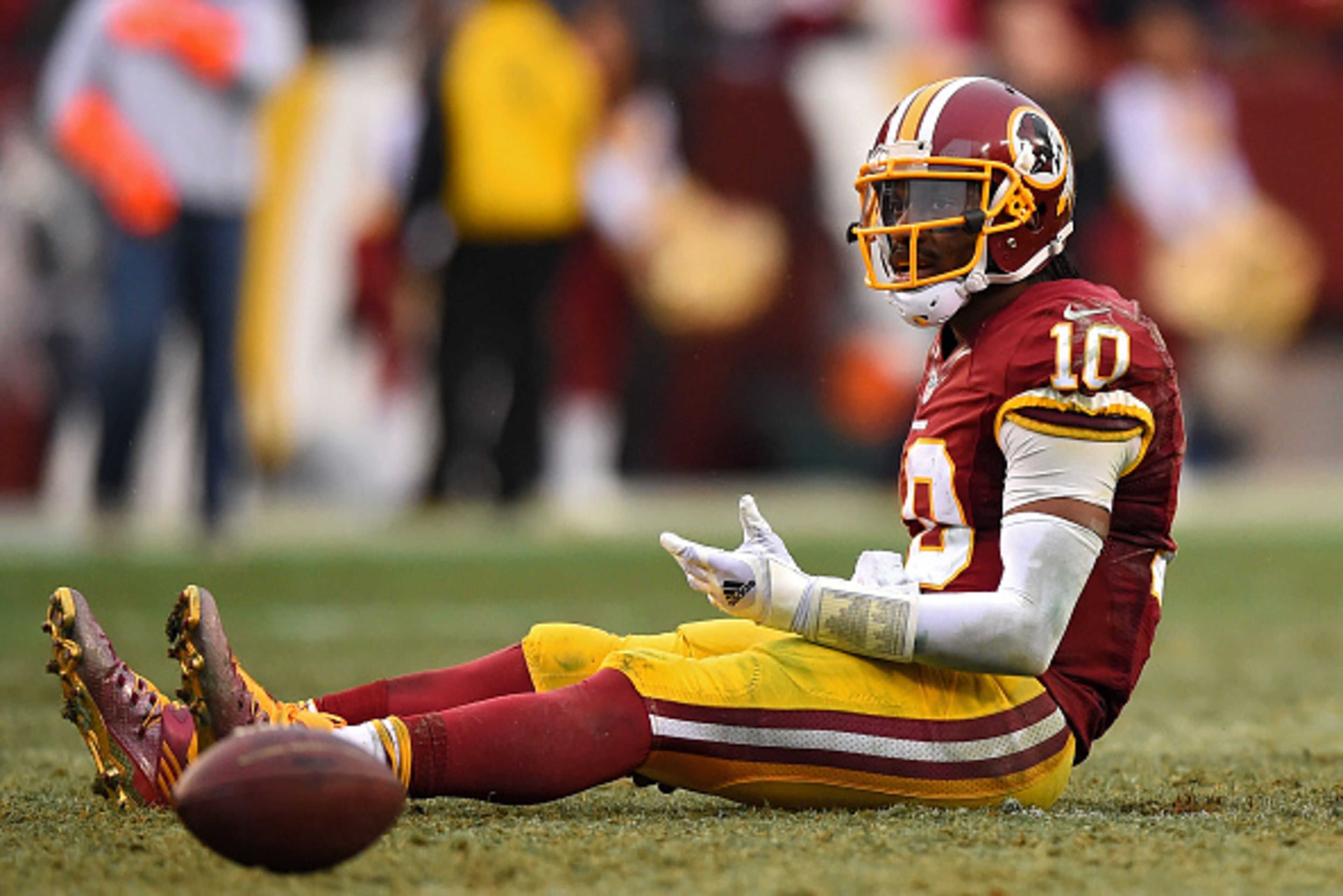 LANDOVER, MD - DECEMBER 28: Quarterback Robert Griffin III #10 of the Washington Redskins reacts after throwing a fourth quarter interception against the Dallas Cowboys at FedExField on December 28, 2014 in Landover, Maryland. The Dallas Cowboys won, 44-1