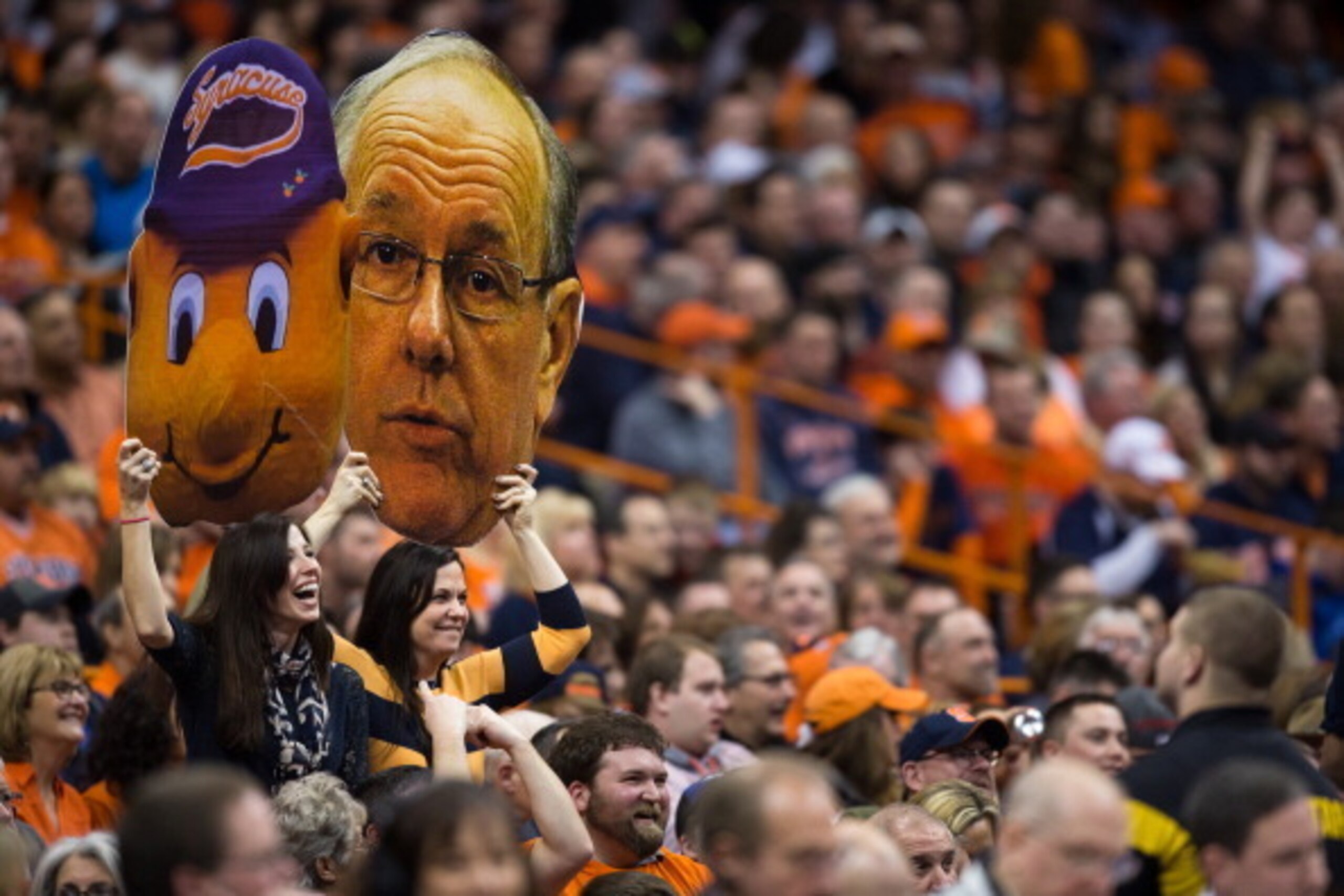 SYRACUSE, NY - FEBRUARY 9:  Syracuse Orange fans hold up jumbo photographs of the team's mascot Otto and head coach Jim Boeheim of the Syracuse Orange during a game against Clemson Tigers on February 9, 2014 at The Carrier Dome in Syracuse, New York.  Syr