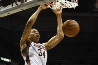 Jan 6, 2015; Milwaukee, WI, USA;  Milwaukee Bucks guard Giannis Antetokounmpo (34) dunks against the Phoenix Suns in the second quarter at BMO Harris Bradley Center. Mandatory Credit: Benny Sieu-USA TODAY Sports