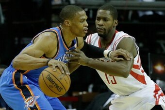 HOUSTON, TX - DECEMBER 29:  Russell Westbrook #0 of the Oklahoma City Thunder is defended by Toney Douglas #15 of the Houston Rockets at the Toyota Center on December 29, 2012 in Houston, Texas. NOTE TO USER: User expressly acknowledges and agrees that, b