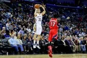 Feb 2, 2015; New Orleans, LA, USA; New Orleans Pelicans guard Jimmer Fredette (32) shoots over Atlanta Hawks guard Dennis Schroder (17) during the first quarter of a game at the Smoothie King Center. The Pelicans defeated the Hawks 115-100.  Mandatory Cre