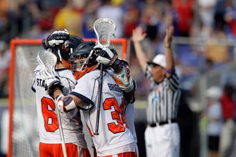 BALTIMORE, MD - MAY 30:  Colin Briggs #34 of the Virginia Cavaliers (R) celebrates his goal with teammate Steele Stanwick #6 against the Maryland Terrapins during the second  half at M&T Bank Stadium on May 30, 2011 in Baltimore, Maryland.  (Photo by Rob 