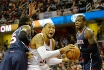 Dec 17, 2014; Cleveland, OH, USA;  Cleveland Cavaliers forward Shawn Marion (31) drives between Atlanta Hawks forward DeMarre Carroll (5) and forward Paul Millsap (4) in the first quarter at Quicken Loans Arena. Mandatory Credit: David Richard-USA TODAY S
