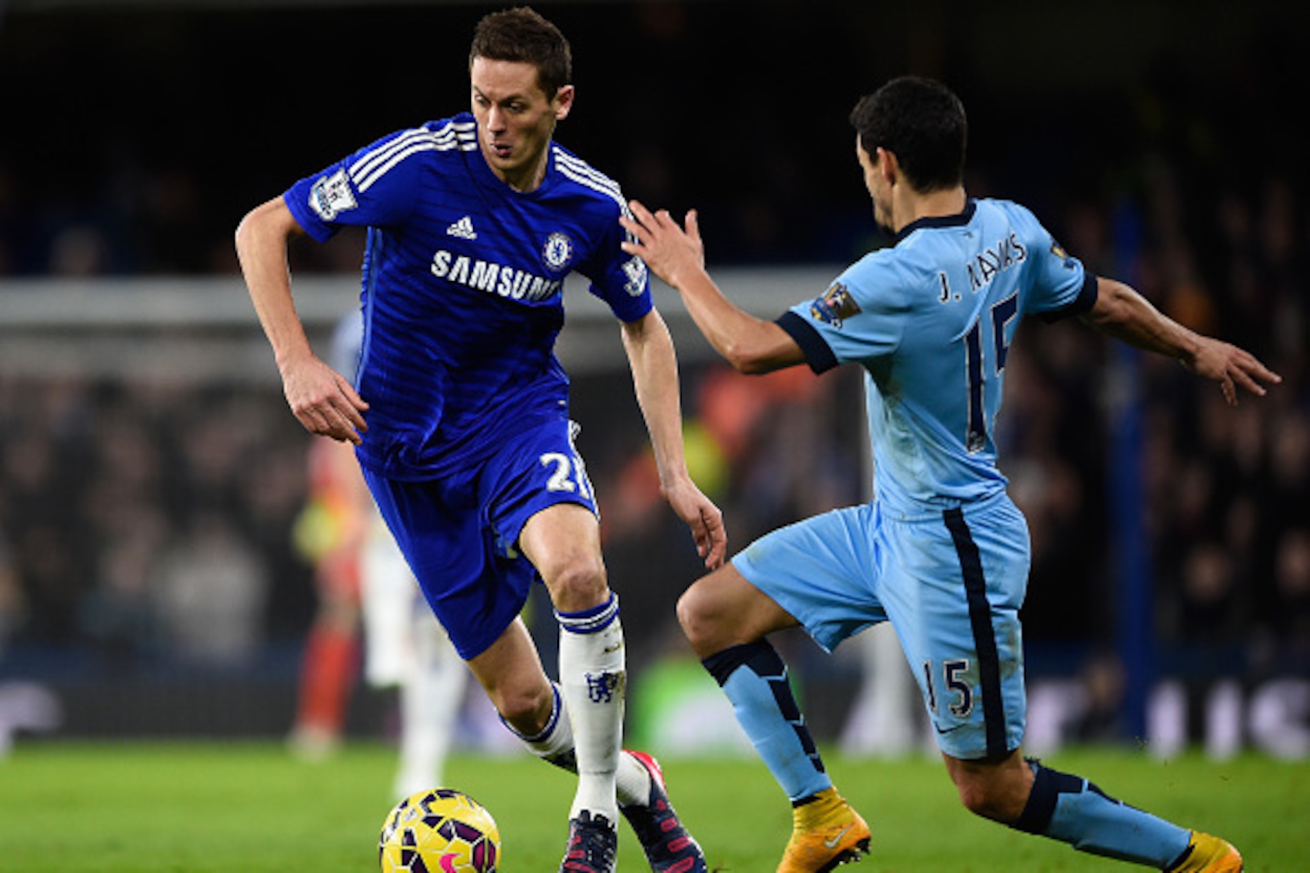 LONDON, ENGLAND - JANUARY 31:  Nemanja Matic of Chelsea (L) avoids the challenge of Jesus Navas of Manchester City (R) during the Barclays Premier League match between Chelsea and Manchester City at Stamford Bridge on January 31, 2015 in London, England. 