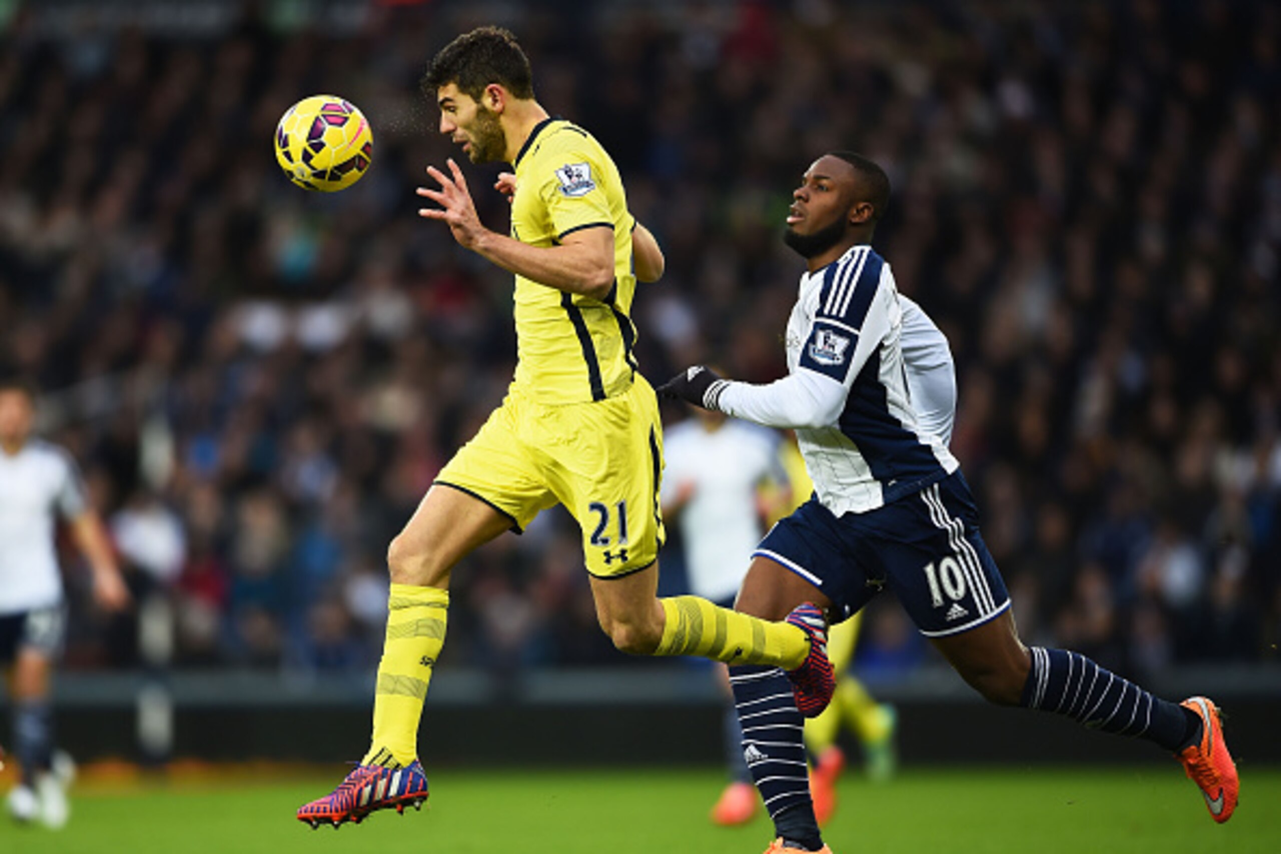 WEST BROMWICH, ENGLAND - JANUARY 31:  Federico Fazio of Spurs clears the ball under pressure from Victor Anichebe of West Brom during the Barclays Premier League match between West Bromwich Albion and Tottenham Hotspur at The Hawthorns on January 31, 2015