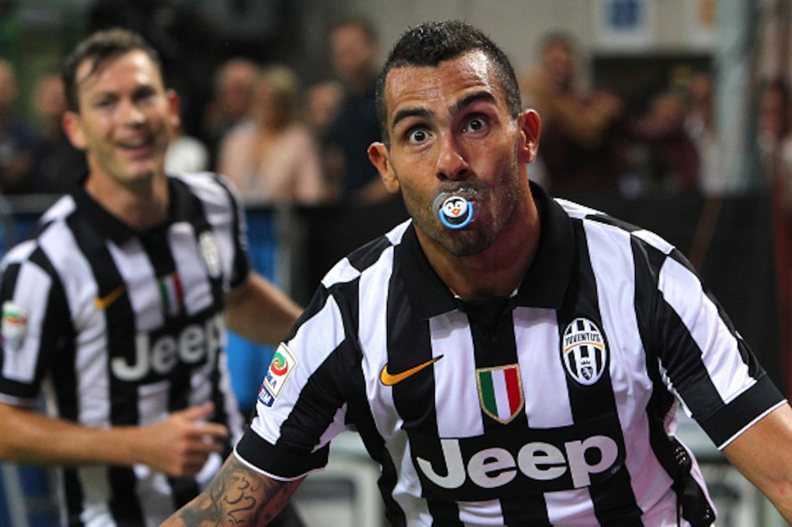 MILAN, ITALY - SEPTEMBER 20:  Carlos Tevez of Juventus FC celebrates after scoring the opening goal during the Serie A match between AC Milan and Juventus FC at Stadio Giuseppe Meazza on September 20, 2014 in Milan, Italy.  (Photo by Marco Luzzani/Getty I