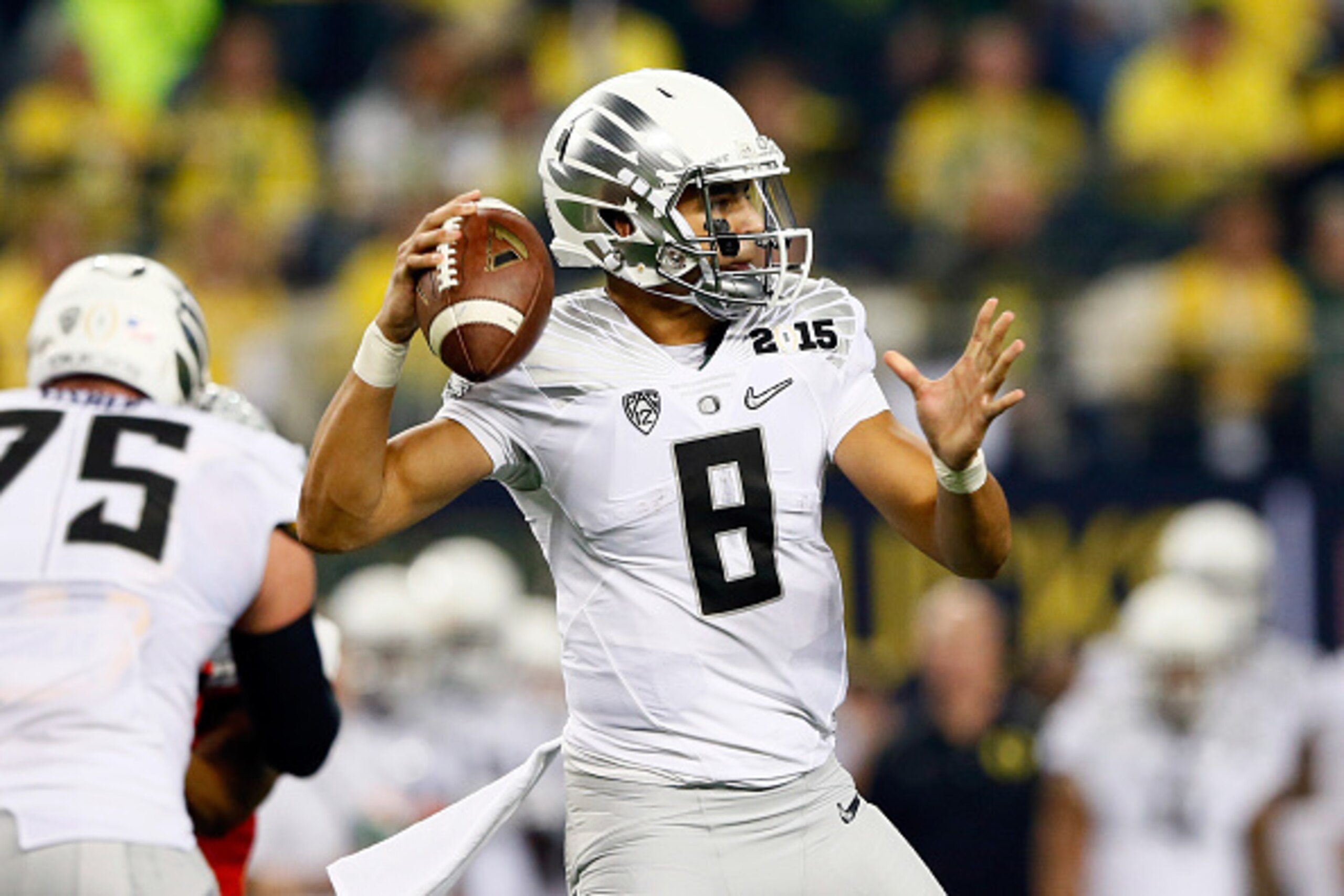 ARLINGTON, TX - JANUARY 12:  Quarterback Marcus Mariota #8 of the Oregon Ducks throws the ball in the first half against the Ohio State Buckeyes during the College Football Playoff National Championship Game at AT&T Stadium on January 12, 2015 in Arlingto