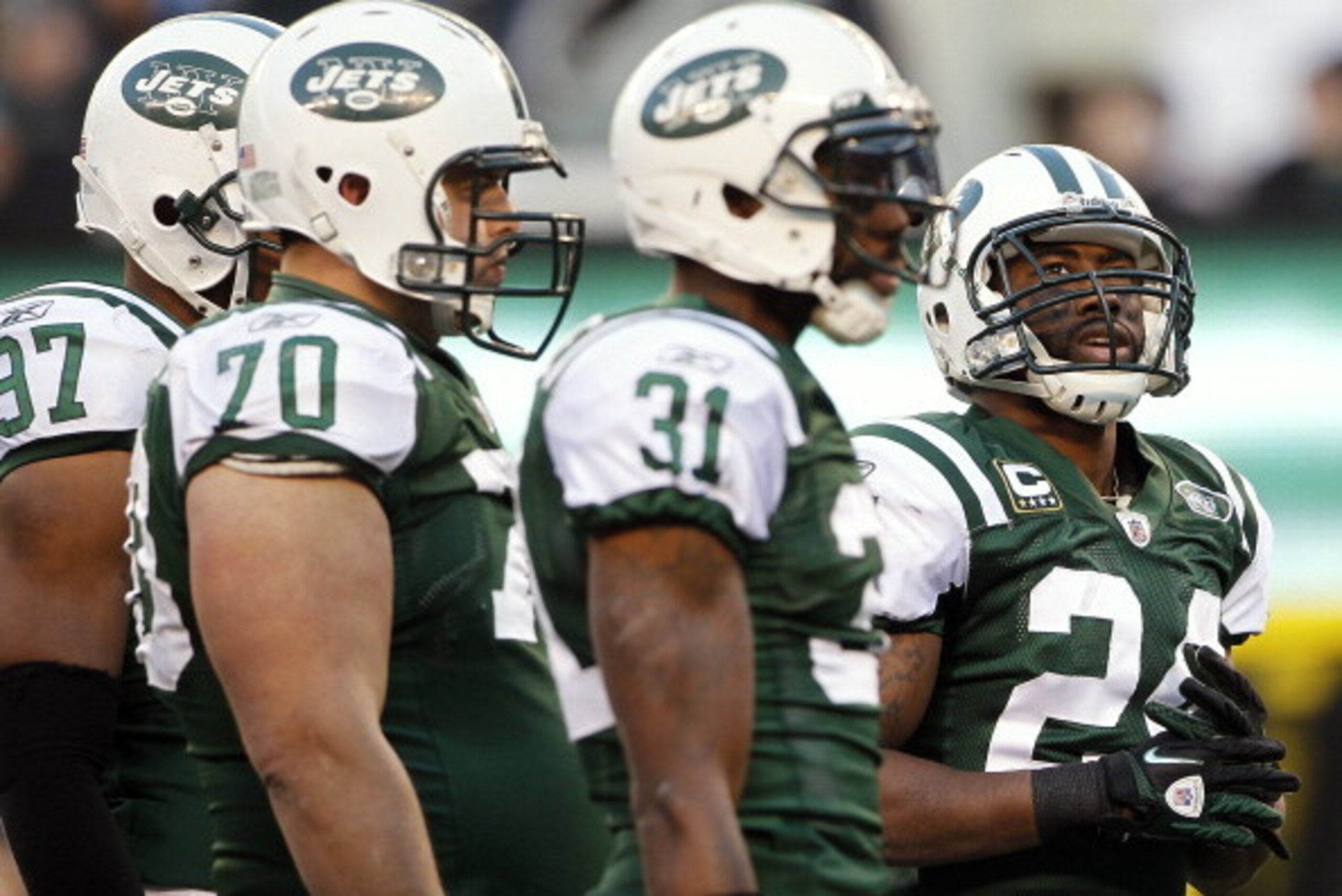 EAST RUTHERFORD, NJ - DECEMBER 24: Darrelle Revis #24 of the New York Jets looks up at the score board as he stands next to teammates Calvin Pace #97, Mike DeVito #70 and Antonio Cromartie #31during a game against the New York Giants at MetLife Stadium on