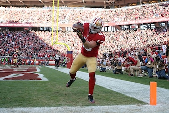 SANTA CLARA, CA - DECEMBER 28: Bruce Miller #49 of the San Francisco 49ers completes a pass for a touchdown in the third quarter against the Arizona Cardinals at Levi's Stadium on December 28, 2014 in Santa Clara, California.  (Photo by Don Feria/Getty Im