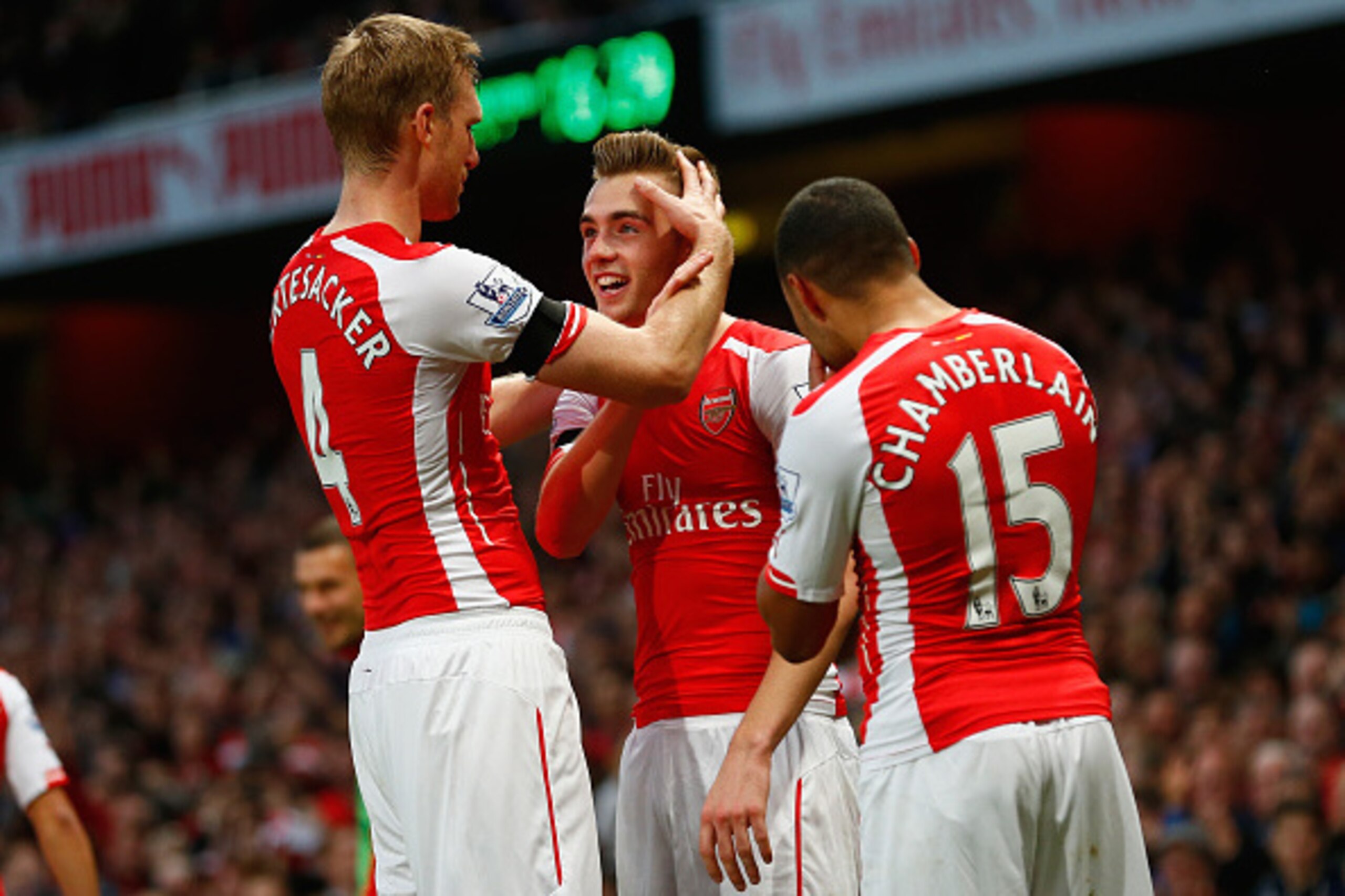 LONDON, ENGLAND - NOVEMBER 01:  Calum Chambers of Arsenal celebrates scoring the second goal for Arsenal with Per Mertesacker of Arsenal and Alex Oxlade-Chamberlain of Arsenal  during the Barclays Premier League match between Arsenal and Burnley at Emirat