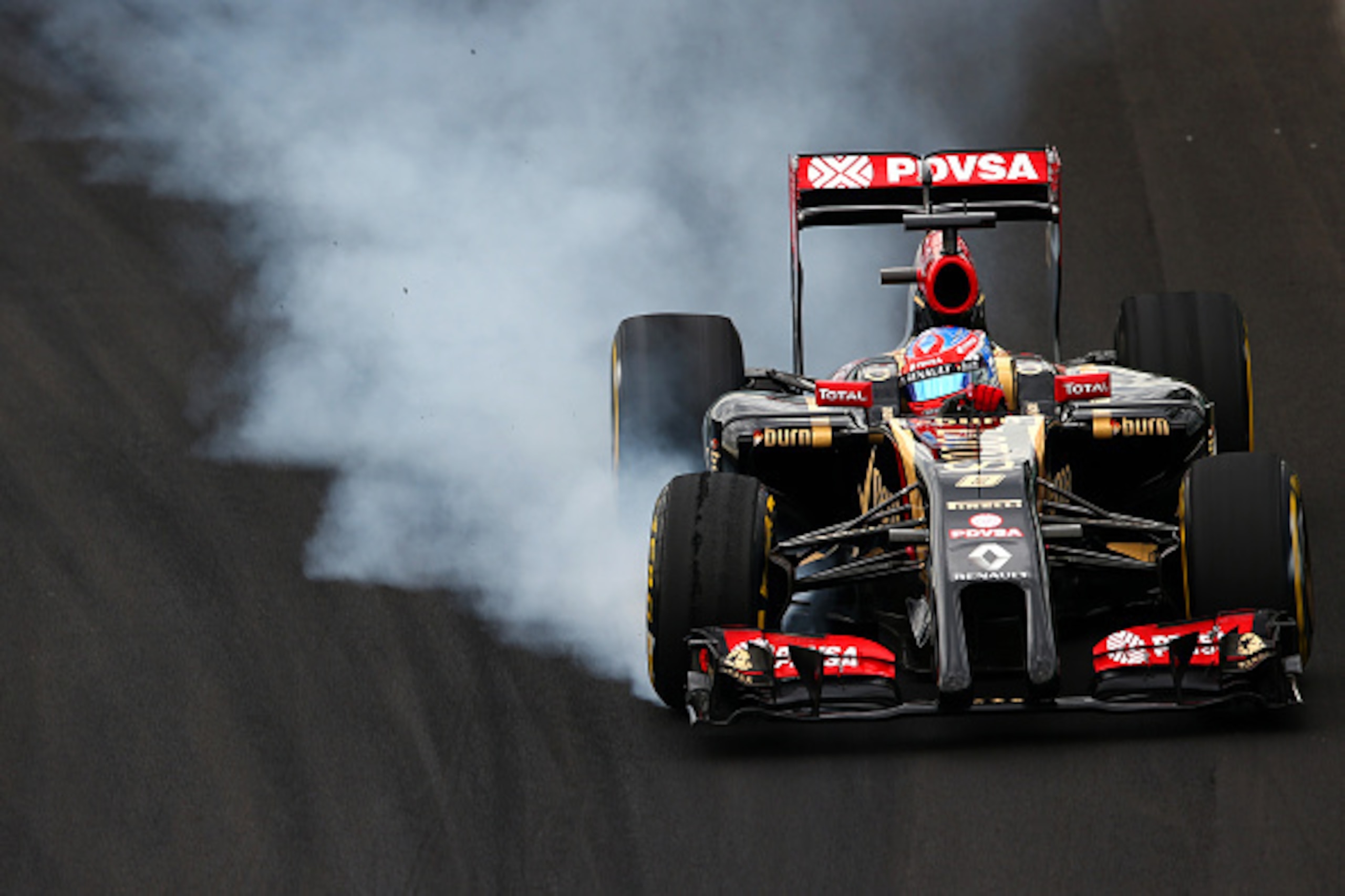 SAO PAULO, BRAZIL - NOVEMBER 08:  Romain Grosjean of France and Lotus locks up during final practice for the Brazilian Formula One Grand Prix at Autodromo Jose Carlos Pace on November 8, 2014 in Sao Paulo, Brazil.  (Photo by Clive Mason/Getty Images)