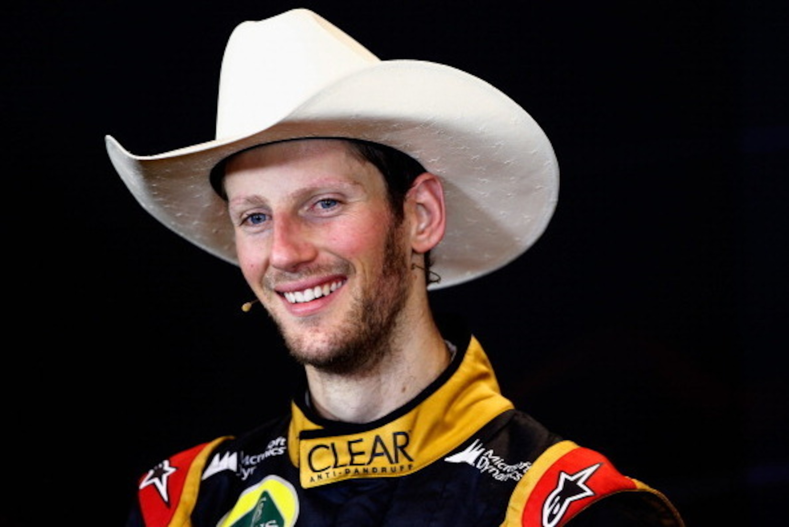 AUSTIN, TX - NOVEMBER 17:  Romain Grosjean of France and Lotus talks with the media after finishing second in the United States Formula One Grand Prix at Circuit of The Americas on November 17, 2013 in Austin, United States.  (Photo by Tom Pennington/Gett