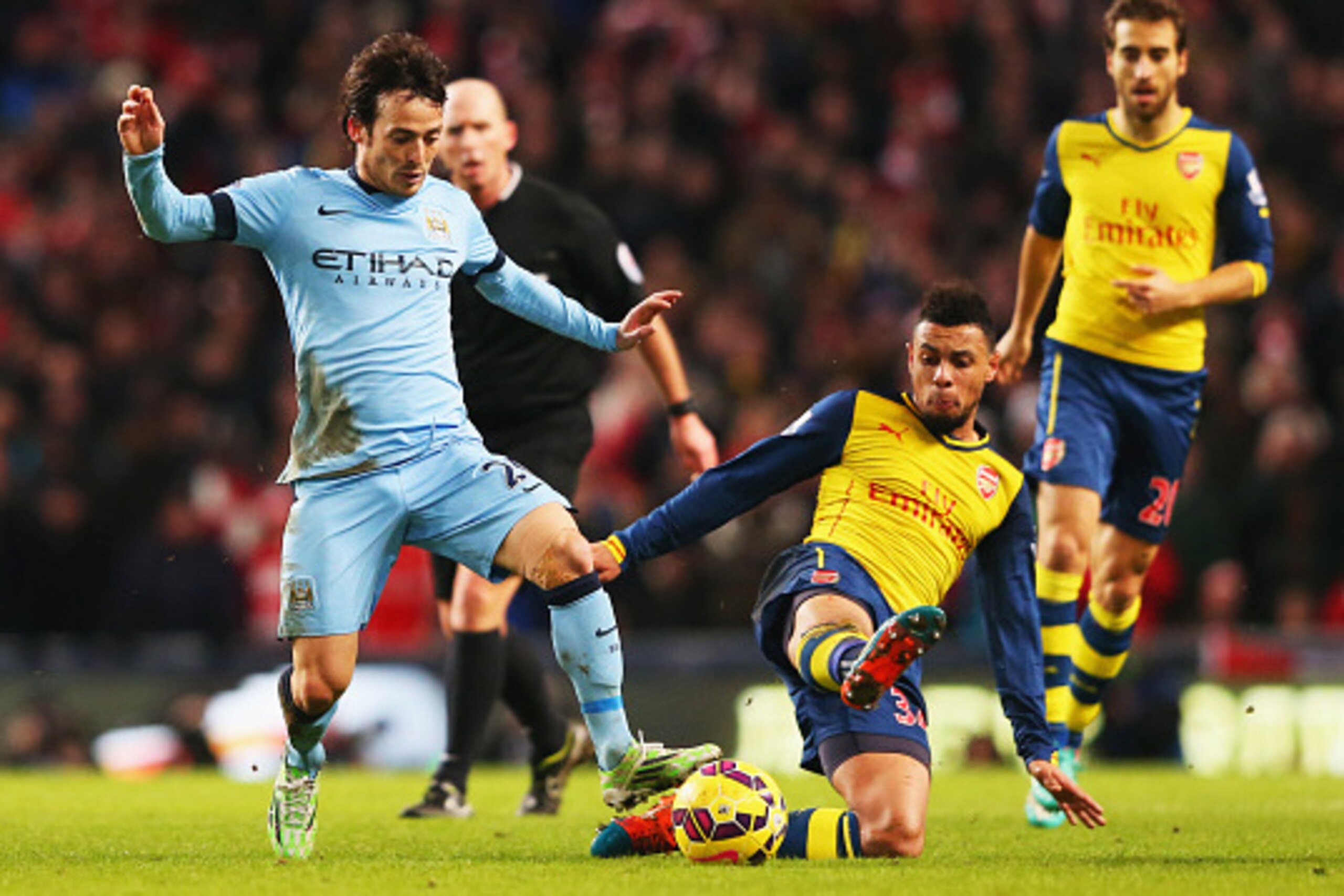 MANCHESTER, ENGLAND - JANUARY 18:  David Silva of Manchester City is tackled by Francis Coquelin of Arsenal during the Barclays Premier League match between Manchester City and Arsenal at Etihad Stadium on January 18, 2015 in Manchester, England.  (Photo 
