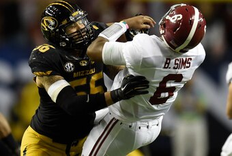 Dec 6, 2014; Atlanta, GA, USA; Missouri Tigers defensive lineman Shane Ray (56) tackles Alabama Crimson Tide quarterback Blake Sims (6) during the second quarter of the 2014 SEC Championship Game at the Georgia Dome. The play caused Ray to be ejected from