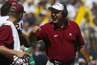 ANN ARBOR, MI - AUGUST 30:  Head coach Mike DeBord of the Central Michigan Chippewas, former offensive coordinator for University of Michigan Wolverines, smiles to strong safety James Kings #24 during the 2003 season opener against the Wolverines at Michi