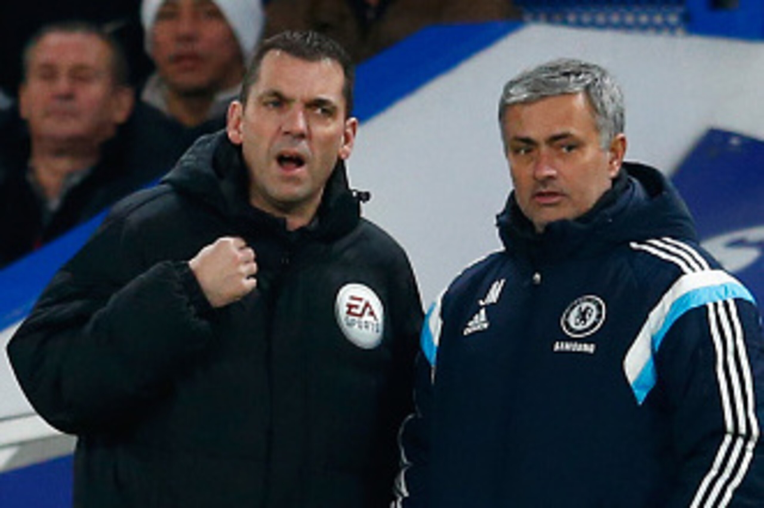 LONDON, ENGLAND - JANUARY 27:  Fourth Official Phil Dowd speaks to Jose Mourinho manager of Chelsea during the Capital One Cup Semi-Final second leg between Chelsea and Liverpool at Stamford Bridge on January 27, 2015 in London, England.  (Photo by Julian