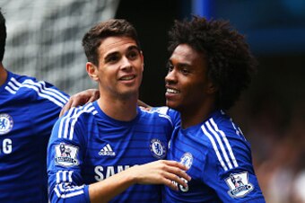 LONDON, ENGLAND - SEPTEMBER 27:  Oscar of Chelsea celebrates with teammates Diego Costa (L) and Willian (R) of Chelsea after scoring the opening goal during the Barclays Premier League match between Chelsea and Aston Villa at Stamford Bridge on September 