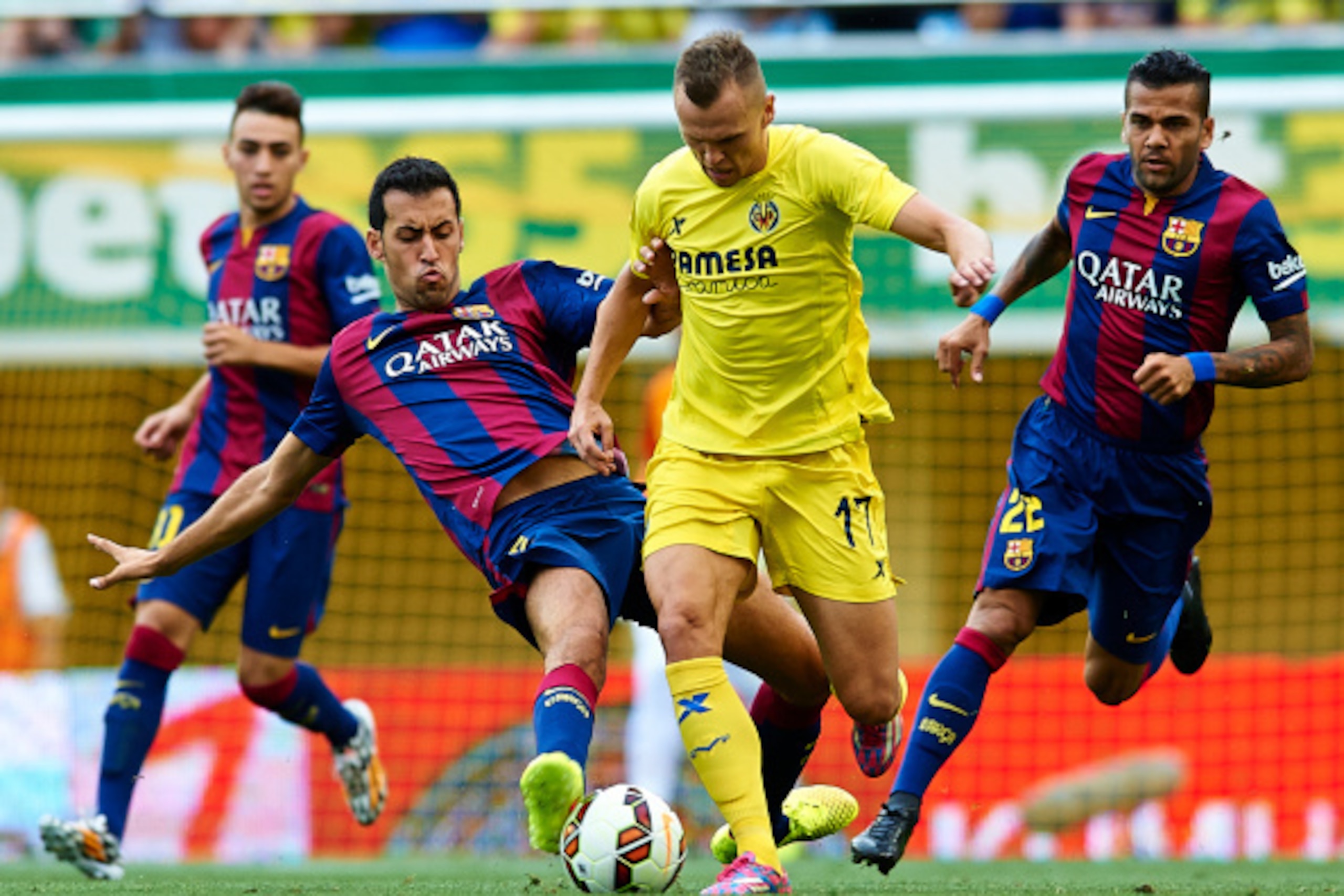VILLARREAL, SPAIN - AUGUST 31: Denis Cheryshev of Villarreal is tackled by Sergio Busquets of Barcelona during the La Liga match between Villarreal CF and FC Barcelona at El Madrigal stadium on August 31, 2014 in Villarreal, Spain. (Photo by Manuel Quei VILLARREAL, SPAIN - AUGUST 31: Denis Cheryshev of Villarreal is tackled by Sergio Busquets of Barcelona during the La Liga match between Villarreal CF and FC Barcelona at El Madrigal stadium on August 31, 2014 in Villarreal, Spain. (Photo by Manuel Quei