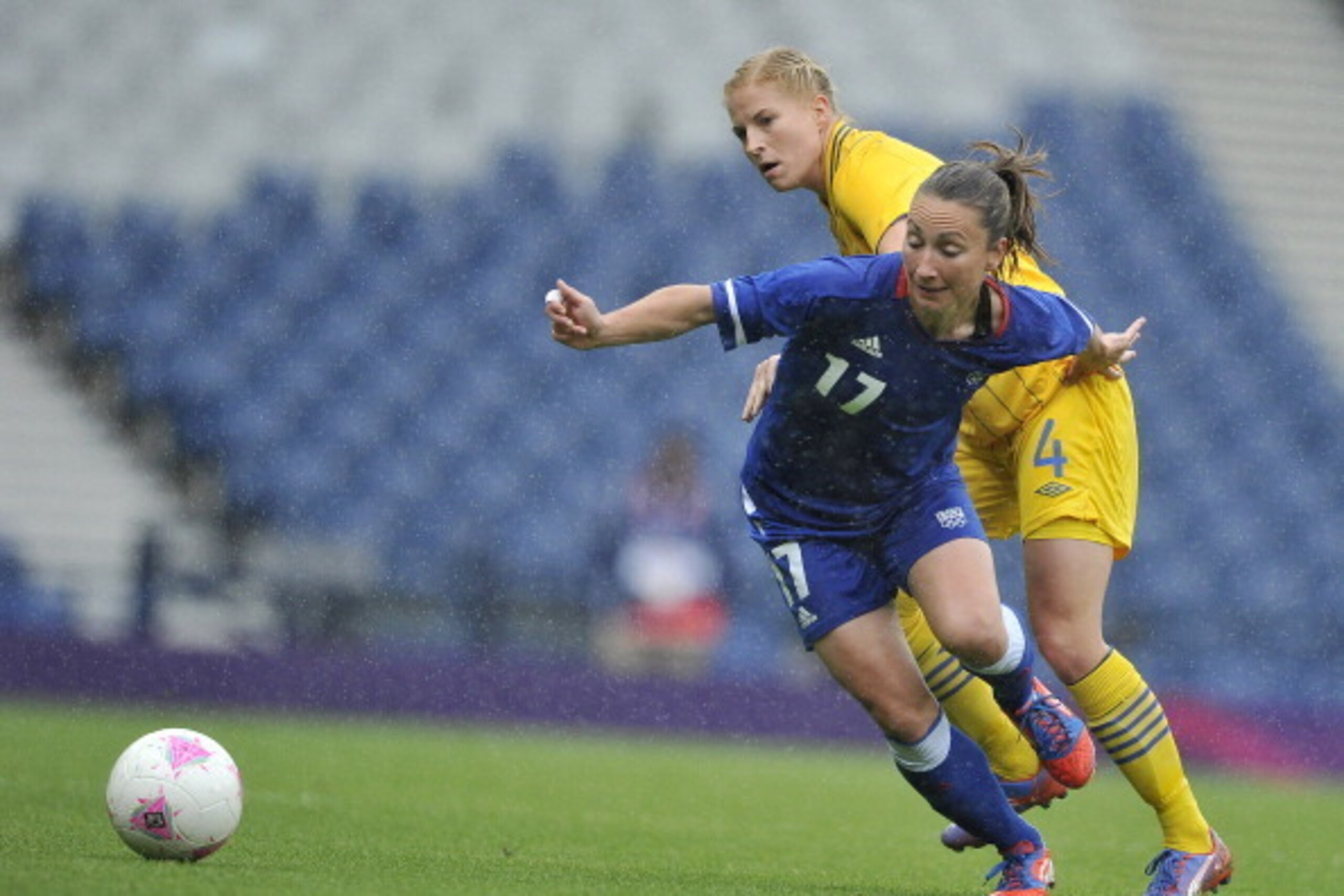 GLASGOW, UNITED KINGDOM - AUGUST 03: Gaetane Thiney of France battles for the ball Annica Svensson of Sweden during the Women's Football Quarter Final match between Sweden and France, on Day 7 of the London 2012 Olympic Games at Hampden Park on August 3 GLASGOW, UNITED KINGDOM - AUGUST 03: Gaetane Thiney of France battles for the ball Annica Svensson of Sweden during the Women's Football Quarter Final match between Sweden and France, on Day 7 of the London 2012 Olympic Games at Hampden Park on August 3