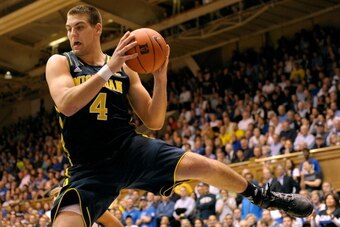 DURHAM, NC - DECEMBER 03:  Mitch McGary #4 of the Michigan Wolverines pulls down a rebound against the Duke Blue Devils at Cameron Indoor Stadium on December 3, 2013 in Durham, North Carolina. Duke won 79-69.  (Photo by Grant Halverson/Getty Images)