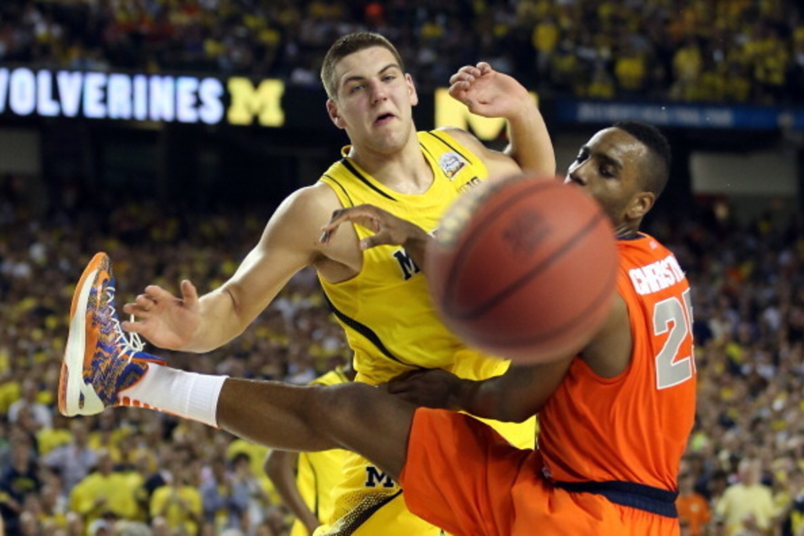 ATLANTA, GA - APRIL 06:  Mitch McGary #4 of the Michigan Wolverines reaches for the bal in the second half against Rakeem Christmas #25 of the Syracuse Orange during the 2013 NCAA Men's Final Four Semifinal at the Georgia Dome on April 6, 2013 in Atlanta,
