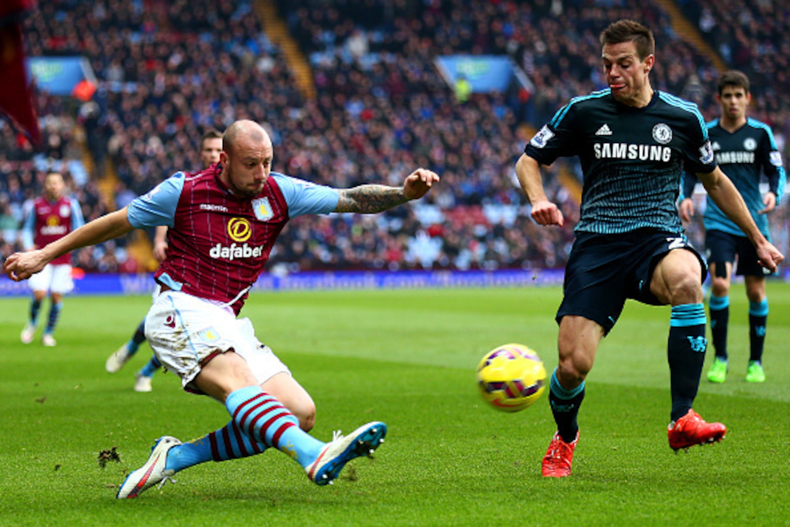 BIRMINGHAM, ENGLAND - FEBRUARY 07:  Alan Hutton of Aston Villa crosses the ball past Cesar Azpilicueta of Chelsea during the Barclays Premier League match between Aston Villa and Chelsea at Villa Park on February 7, 2015 in Birmingham, England.  (Photo by