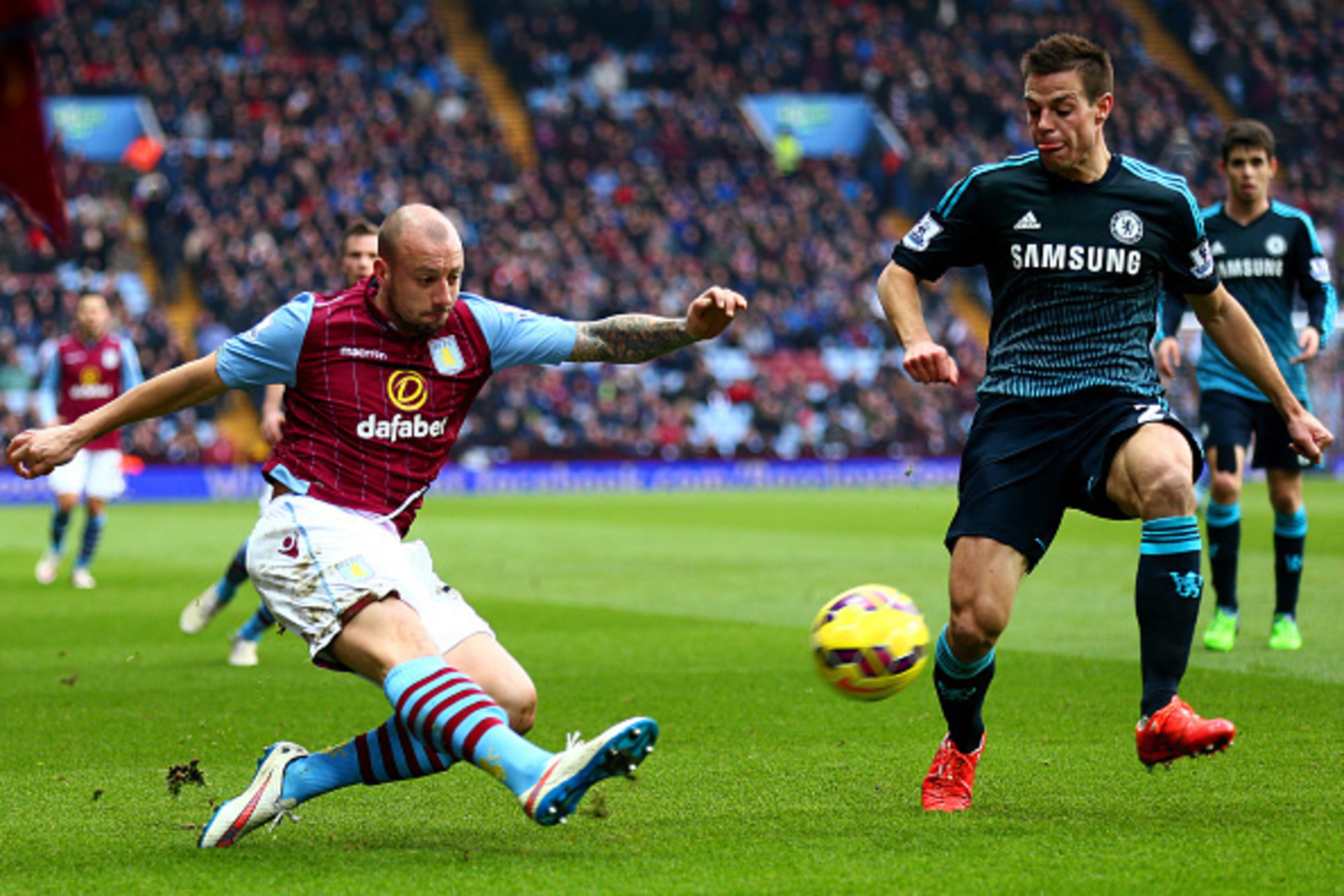 BIRMINGHAM, ENGLAND - FEBRUARY 07:  Alan Hutton of Aston Villa crosses the ball past Cesar Azpilicueta of Chelsea during the Barclays Premier League match between Aston Villa and Chelsea at Villa Park on February 7, 2015 in Birmingham, England.  (Photo by