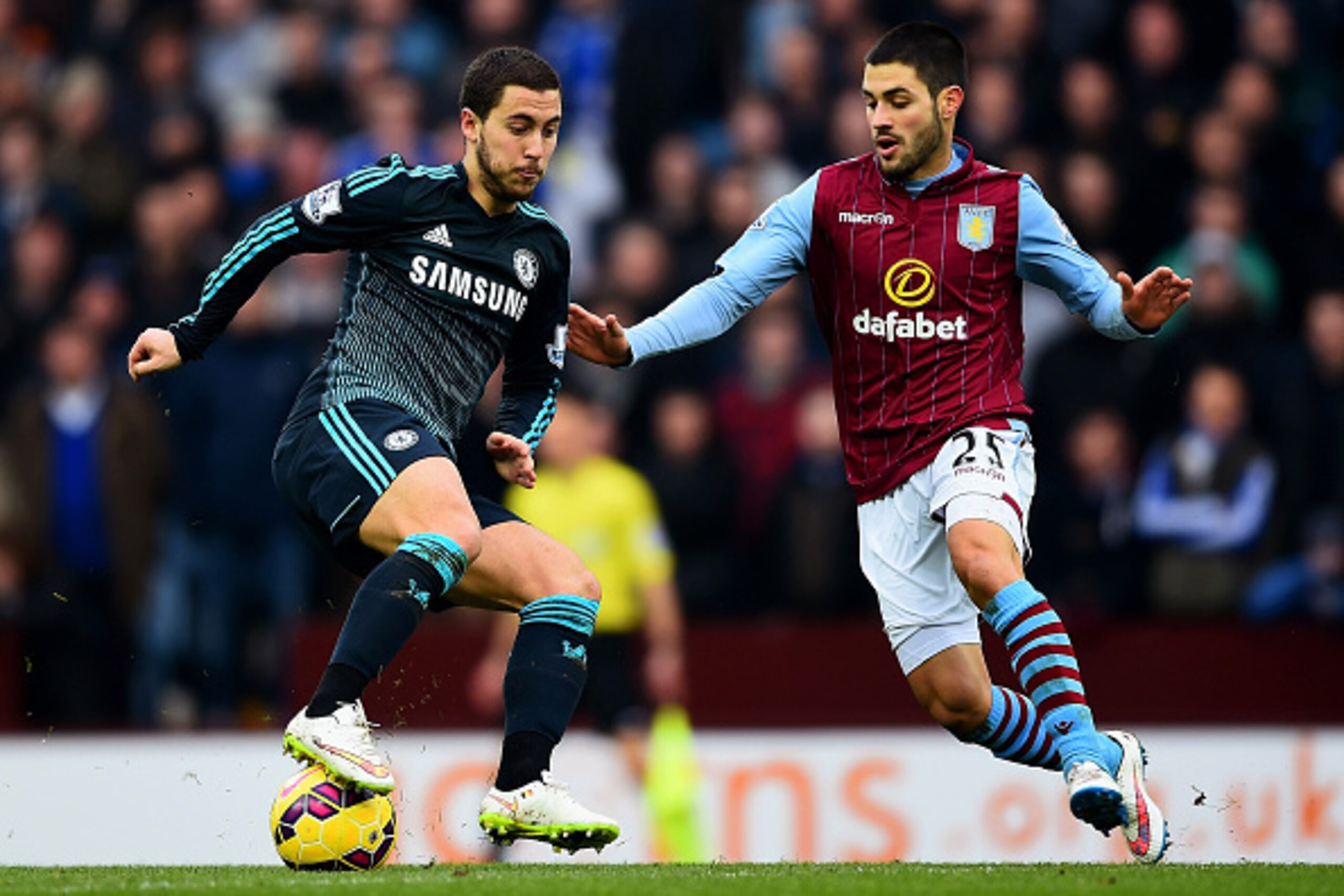 BIRMINGHAM, ENGLAND - FEBRUARY 07:  Eden Hazard of Chelsea battles for the ball with Carles Gil of Aston Villa during the Barclays Premier League match between Aston Villa and Chelsea at Villa Park on February 7, 2015 in Birmingham, England.  (Photo by La