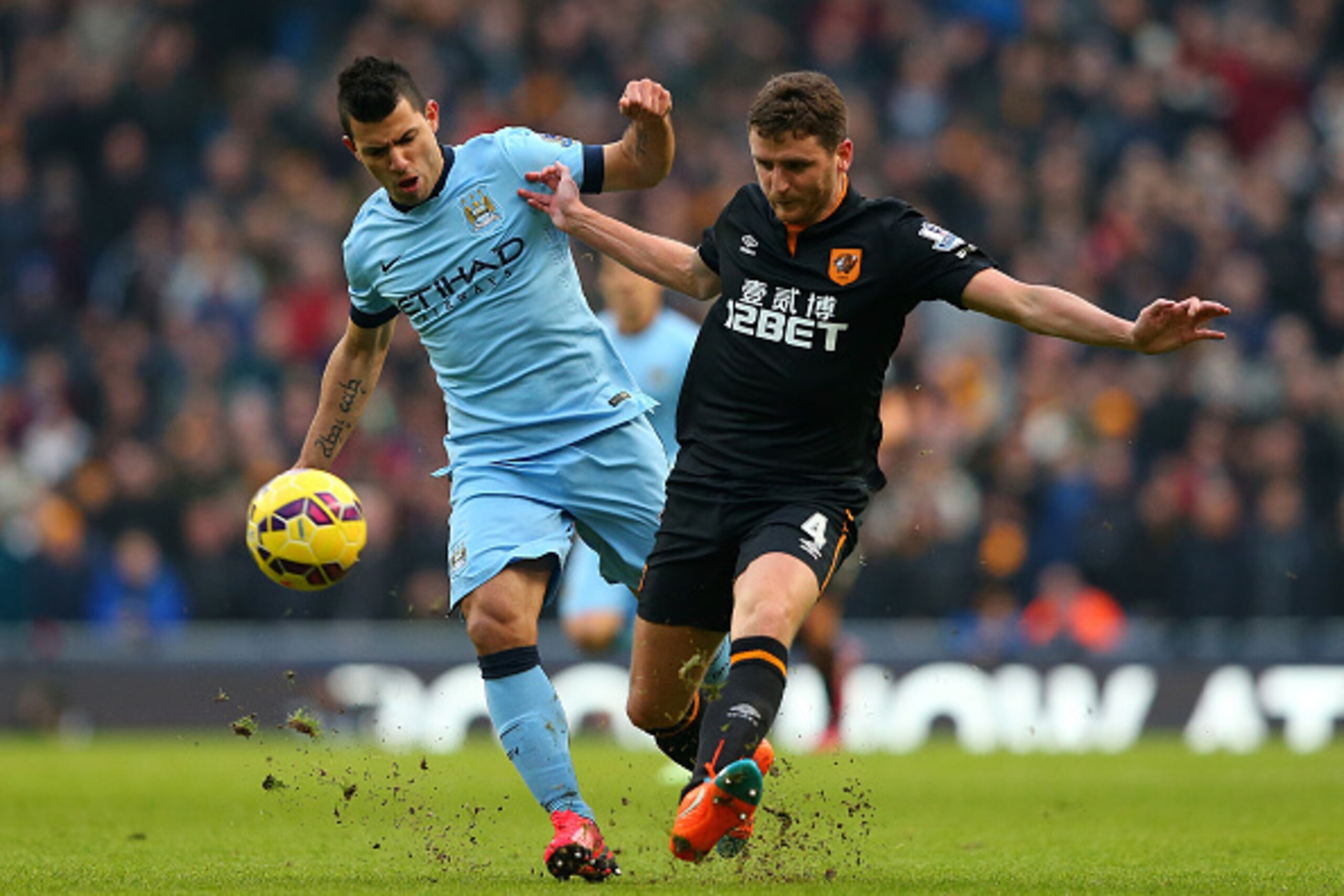 MANCHESTER, ENGLAND - FEBRUARY 07:  Sergio Aguero of Manchester City competes with Alex Bruce of Hull City during the Barclays Premier League match between Manchester City and Hull City at the Etihad Stadium on February 7, 2015 in Manchester, England.  (P
