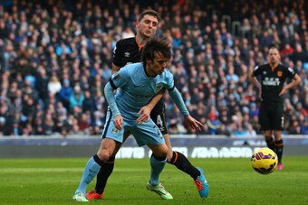 MANCHESTER, ENGLAND - FEBRUARY 07:  Alex Bruce of Hull City tangles in the penalty area with David Silva of Manchester City during the Barclays Premier League match between Manchester City and Hull City at the Etihad Stadium on February 7, 2015 in Manches