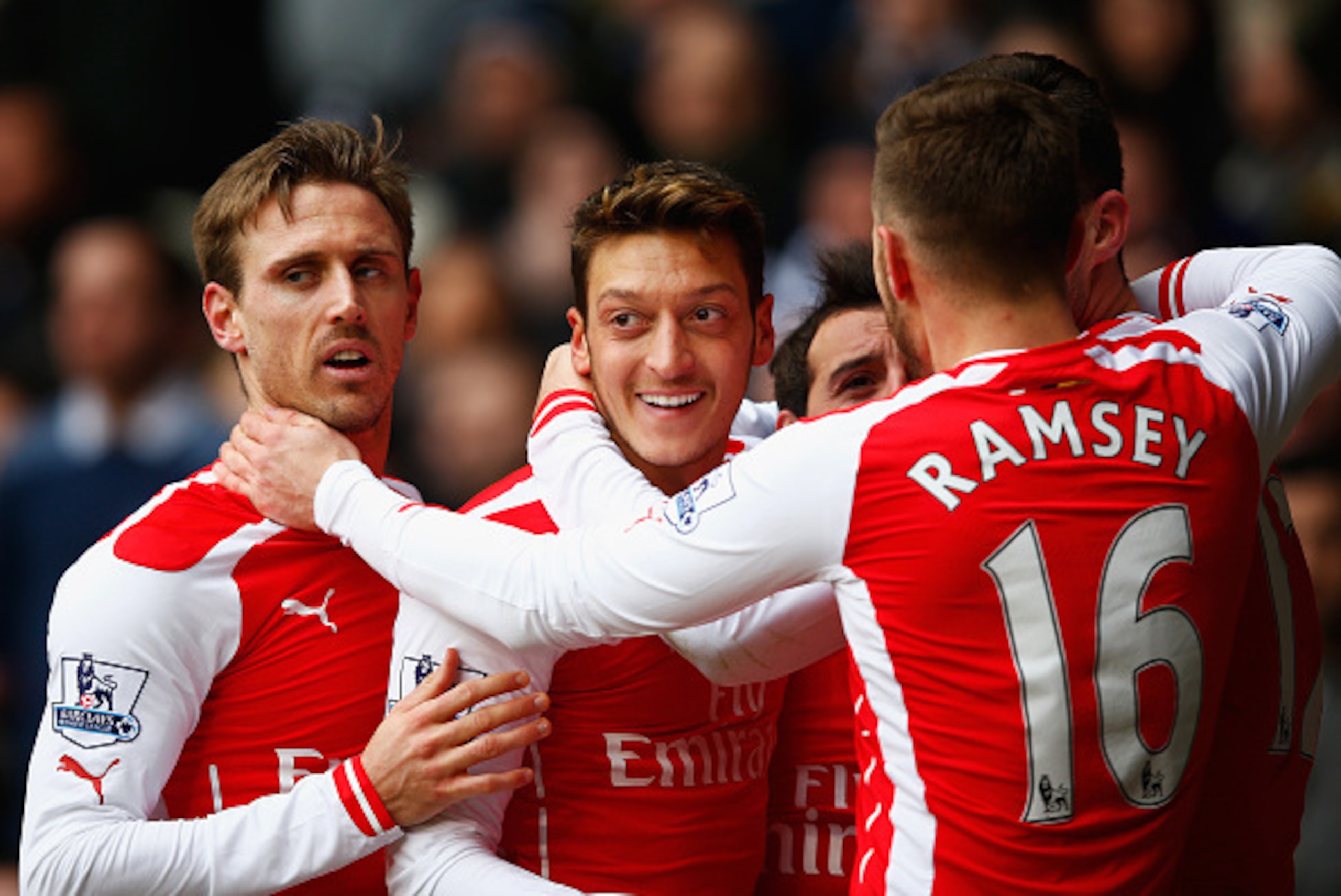 LONDON, ENGLAND - FEBRUARY 07:  Mesut Oezil of Arsenal celebrates scoring the opening goal with team mates during the Barclays Premier League match between Tottenham Hotspur and Arsenal at White Hart Lane on February 7, 2015 in London, England.  (Photo by