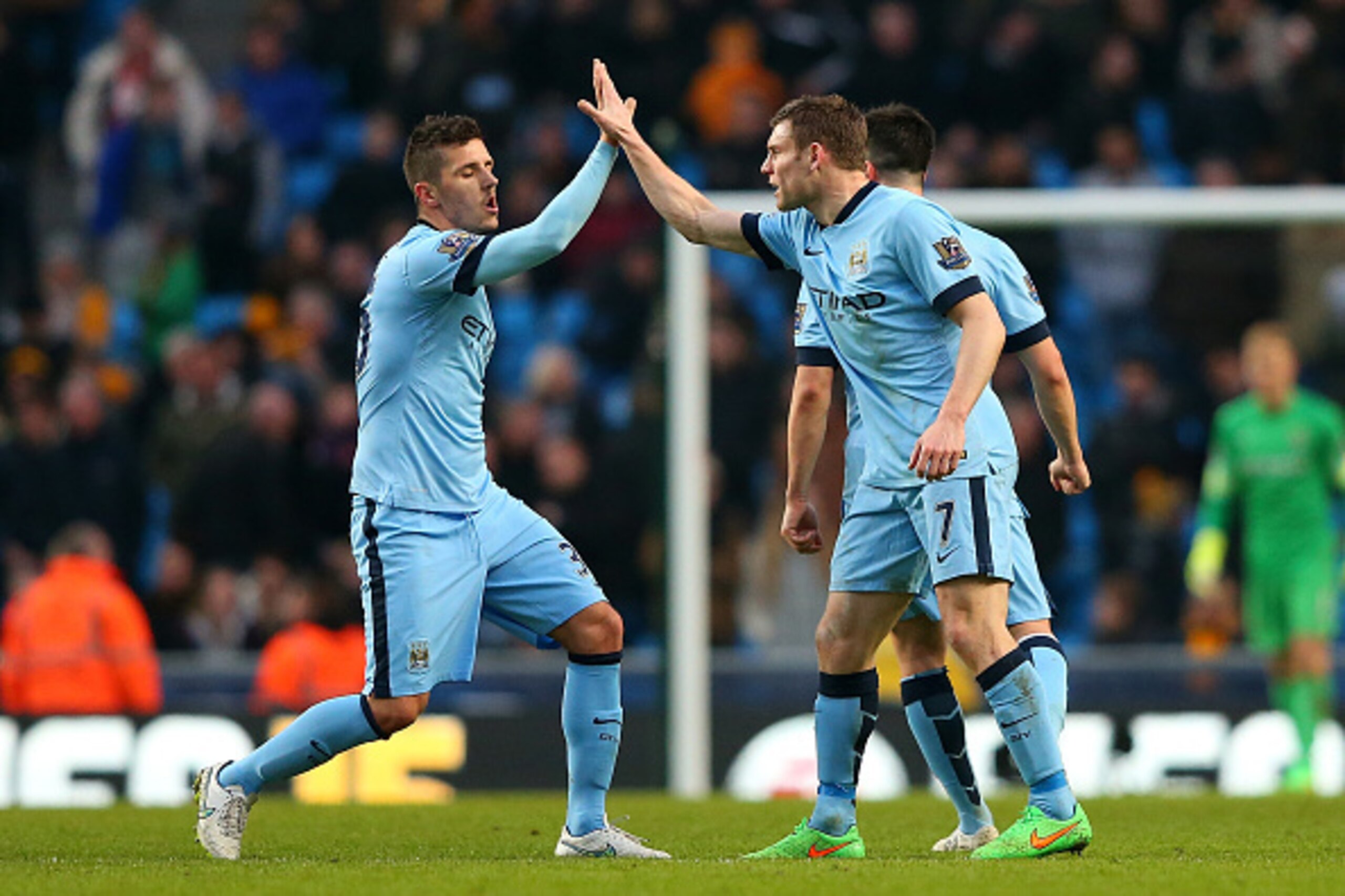 MANCHESTER, ENGLAND - FEBRUARY 07:  James Milner (R) of Manchester City celebrates scoring the equalising goal with team-mate Stevan Jovetic during the Barclays Premier League match between Manchester City and Hull City at the Etihad Stadium on February 7