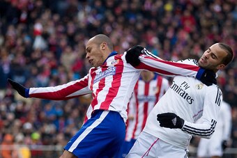 MADRID, SPAIN - FEBRUARY 07: Joao Miranda (L) of Atletico de Madrid and Jese Rodriguez (R) of Real Madrid CF hang themselves during the La Liga match between Club Atletico de Madrid and Real Madrid CF at Vicente Calderon Stadium on February 7, 2015 in Mad